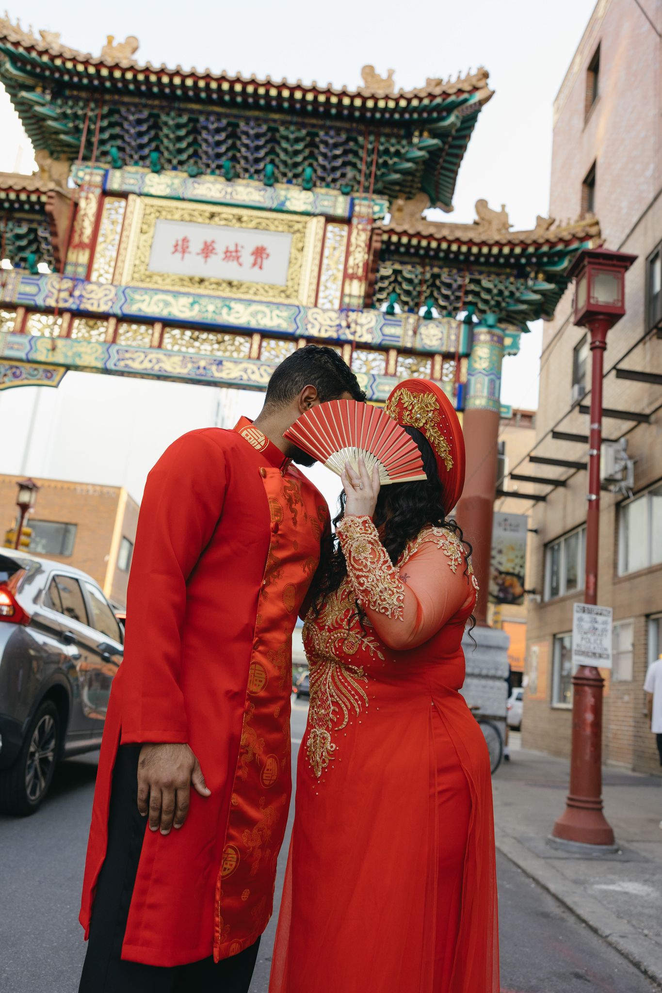 Couple laughing together during an engagement session in Philadelphia Chinatown with city lights and historic architecture-6.jpg