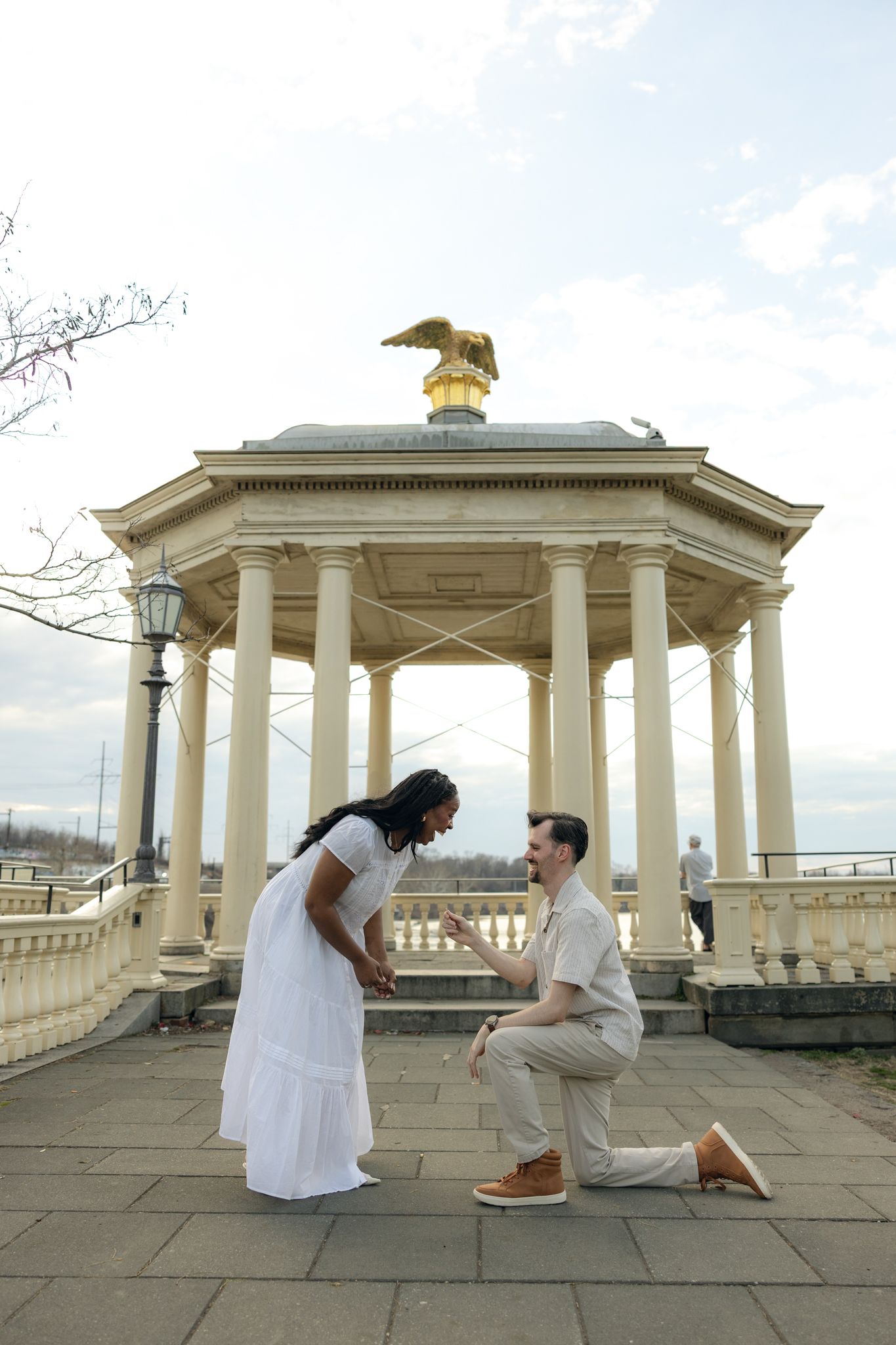 Engaged couple posing at Fairmount Water Works in Philadelphia with scenic river views and historic architecture, capturing romantic engagem