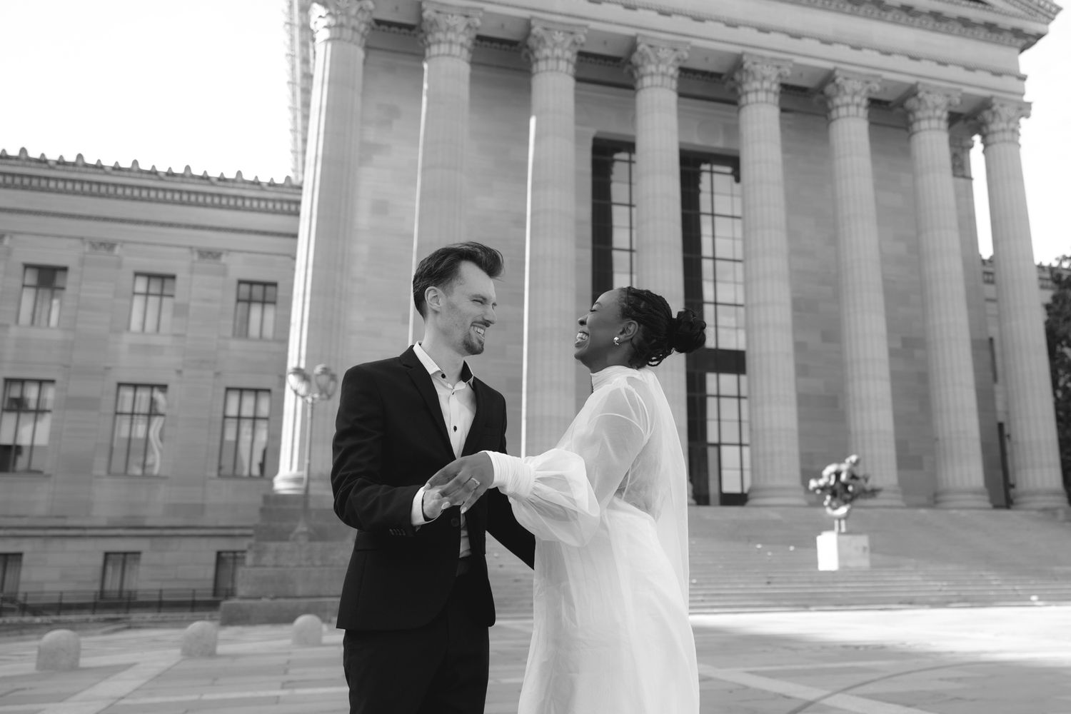 Editorial wedding photography of a bridal couple at the Philadelphia Museum of Art, modern romantic portraits with architectural backdrop