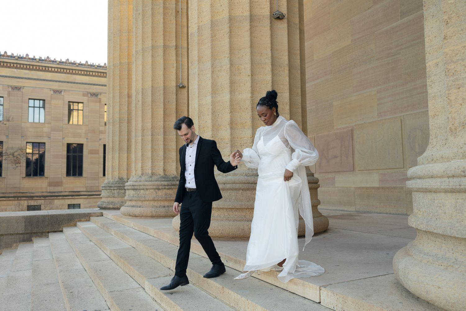 Editorial wedding photography of a bridal couple at the Philadelphia Museum of Art, modern romantic portraits with architectural backdrop