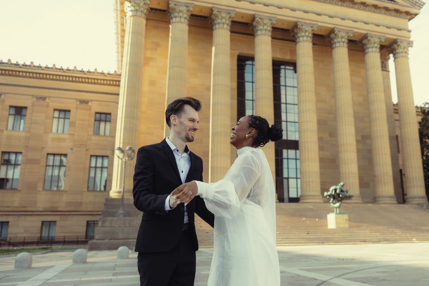 Editorial wedding photography of a bridal couple at the Philadelphia Museum of Art, modern romantic portraits with architectural backdrop