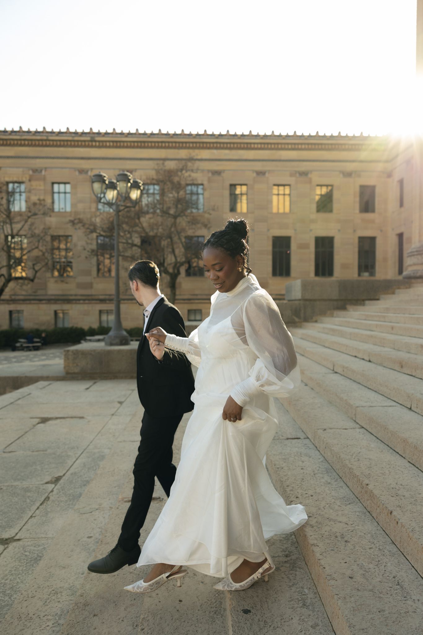 Editorial wedding photography of a bridal couple at the Philadelphia Museum of Art, modern romantic portraits with architectural backdrop