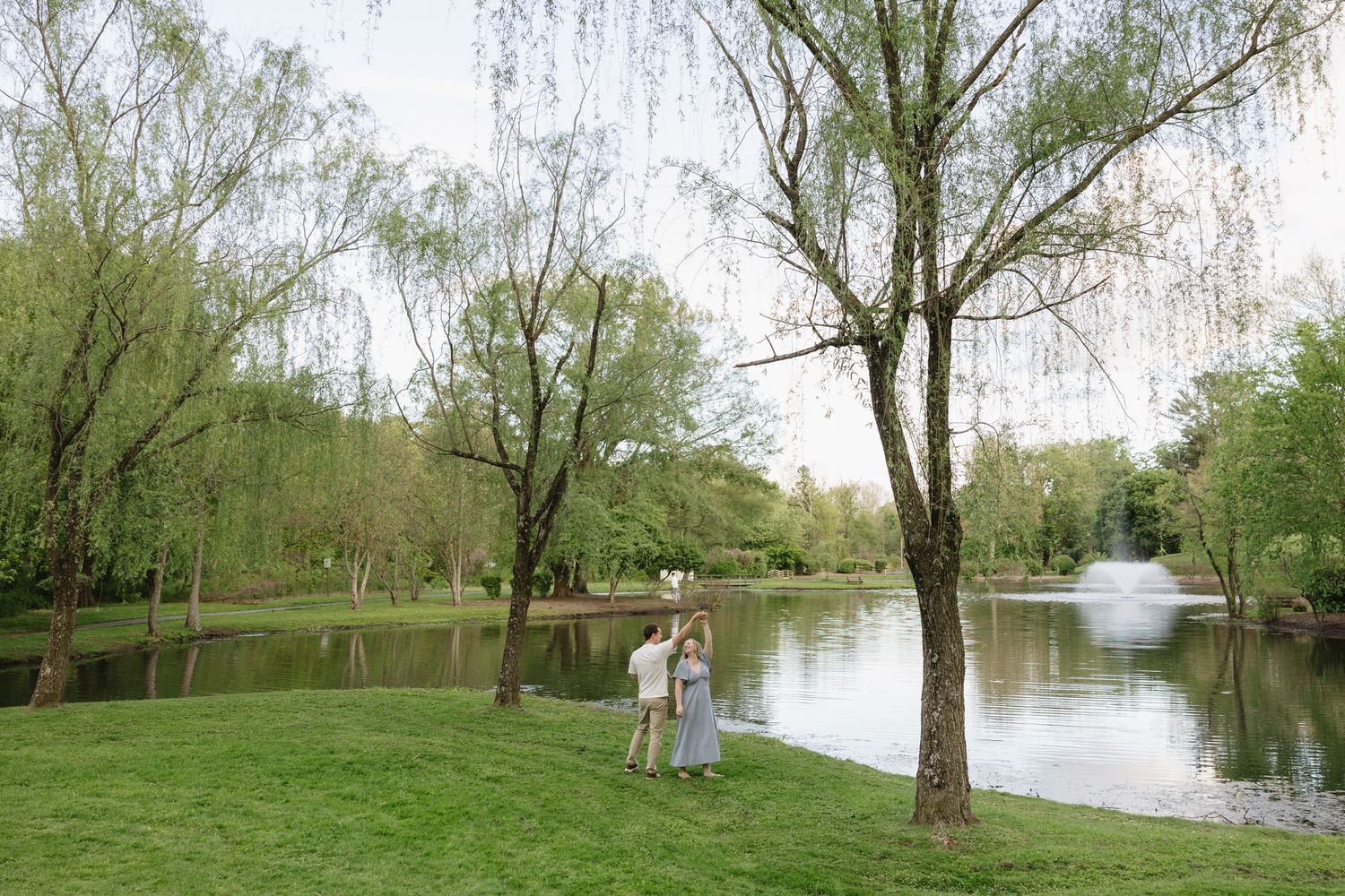 Romantic engagement photos of a couple walking hand in hand through The Willows Park in Villanova, Pennsylvania-1.jpg