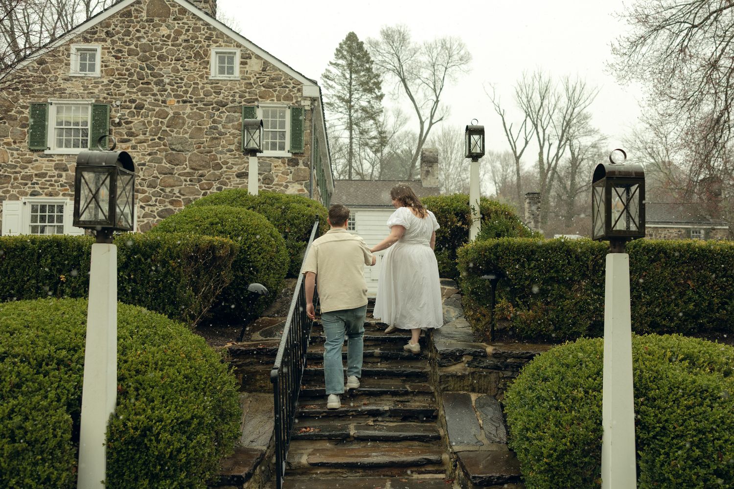 Romantic engagement photos at Appleford Estate near Philadelphia featuring a couple walking through lush gardens and historic architecture