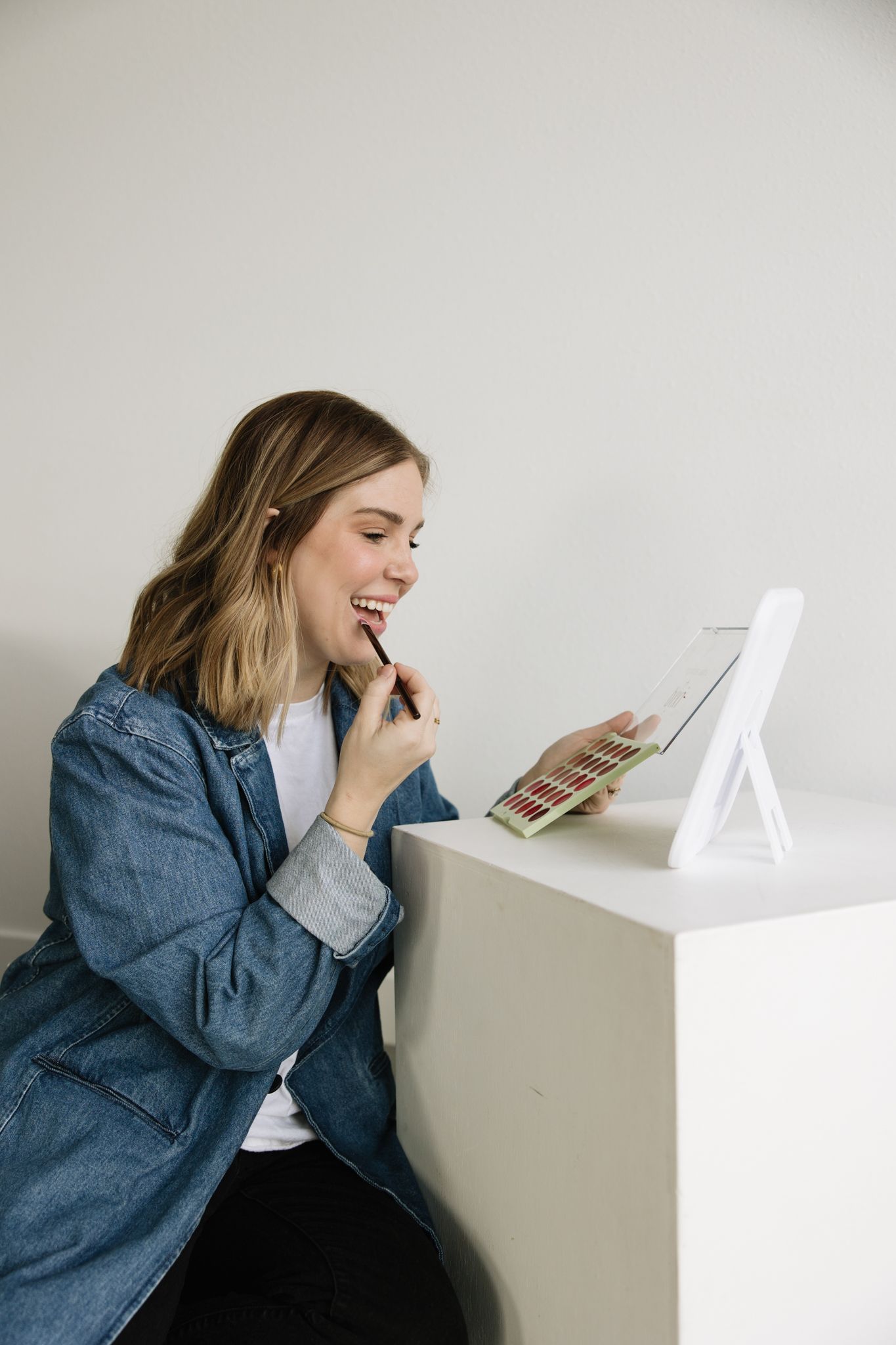 Brand photography in Philadelphia with a small business owner working on a laptop, styled desk details, and candid moments