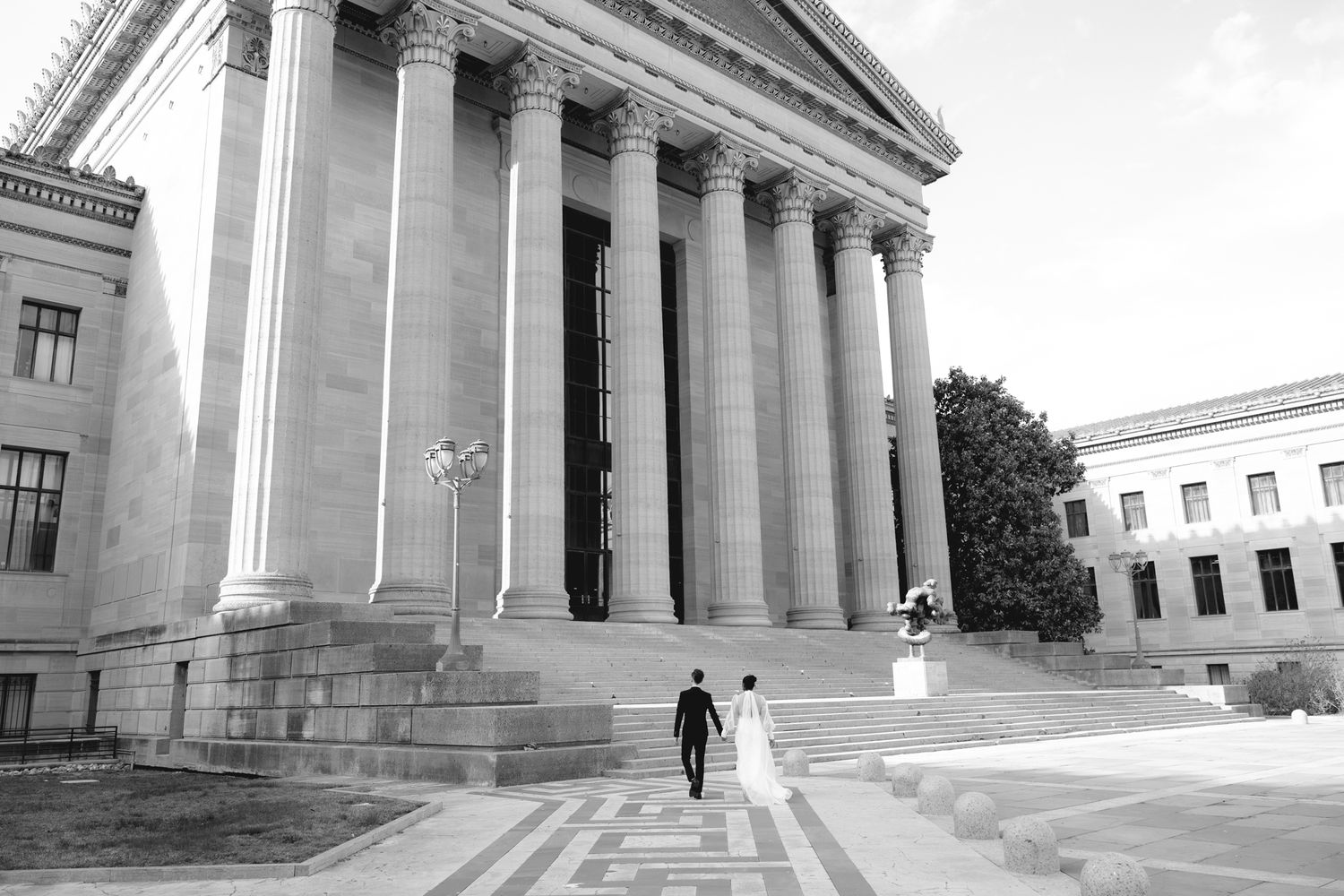 Editorial wedding photography of a bridal couple at the Philadelphia Museum of Art, modern romantic portraits with architectural backdrop