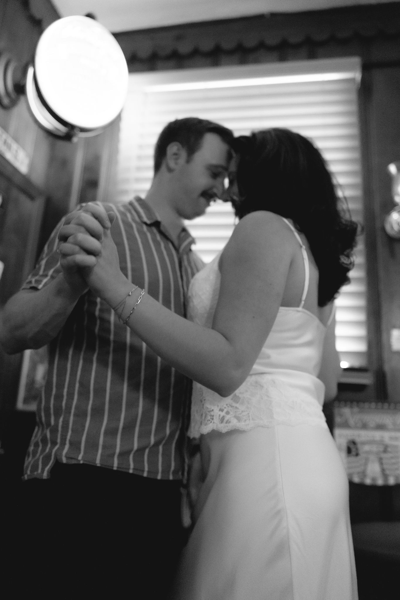 Couple toasting during a playful engagement photo session at a cozy Philadelphia cocktail bar-1.jpg