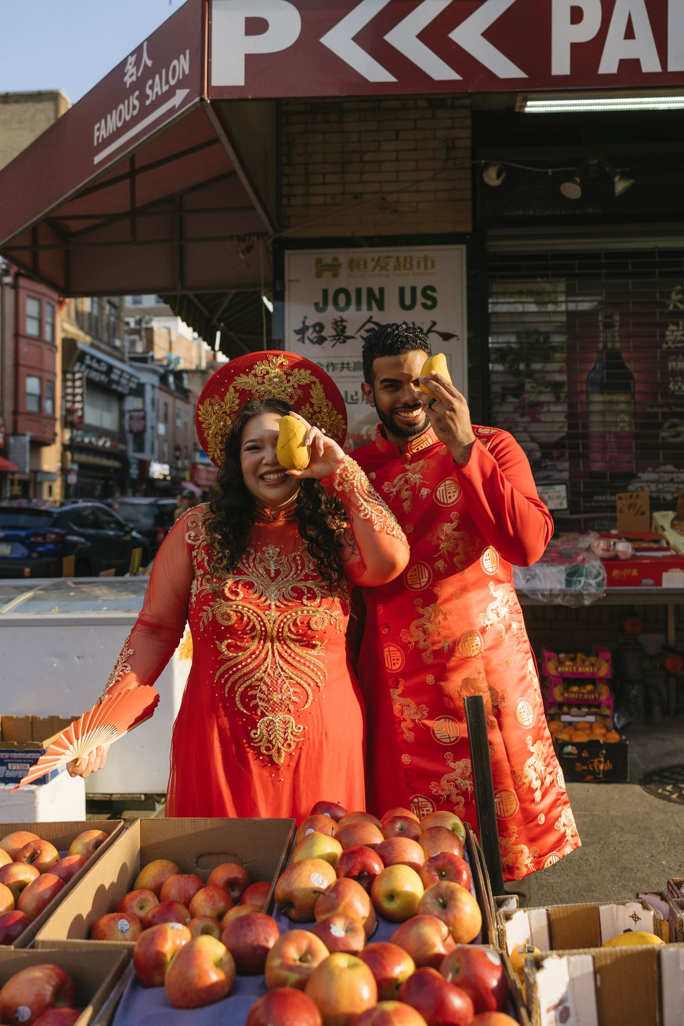 Couple laughing together during an engagement session in Philadelphia Chinatown with city lights and historic architecture-6.jpg
