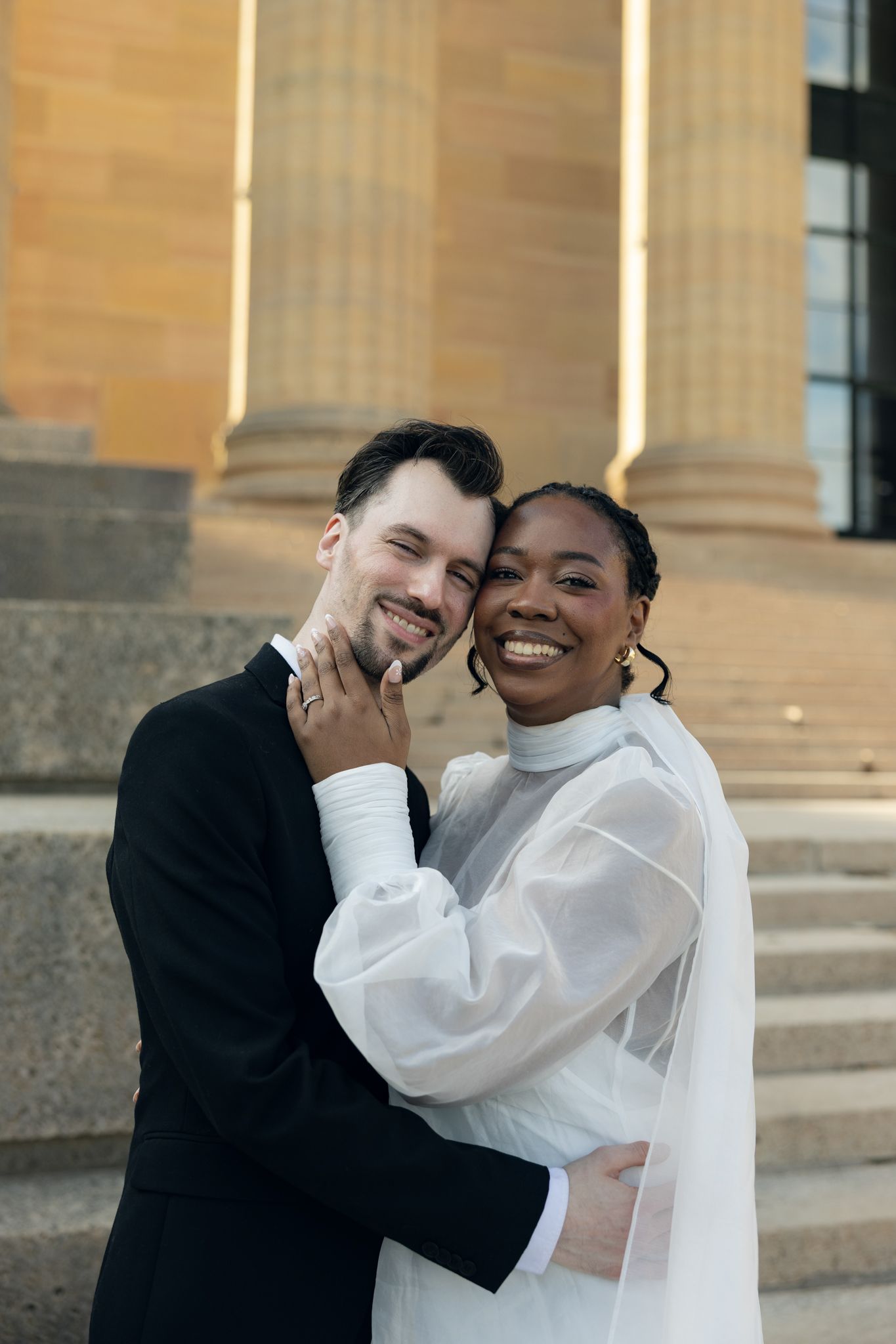 Editorial wedding photography of a bridal couple at the Philadelphia Museum of Art, modern romantic portraits with architectural backdrop