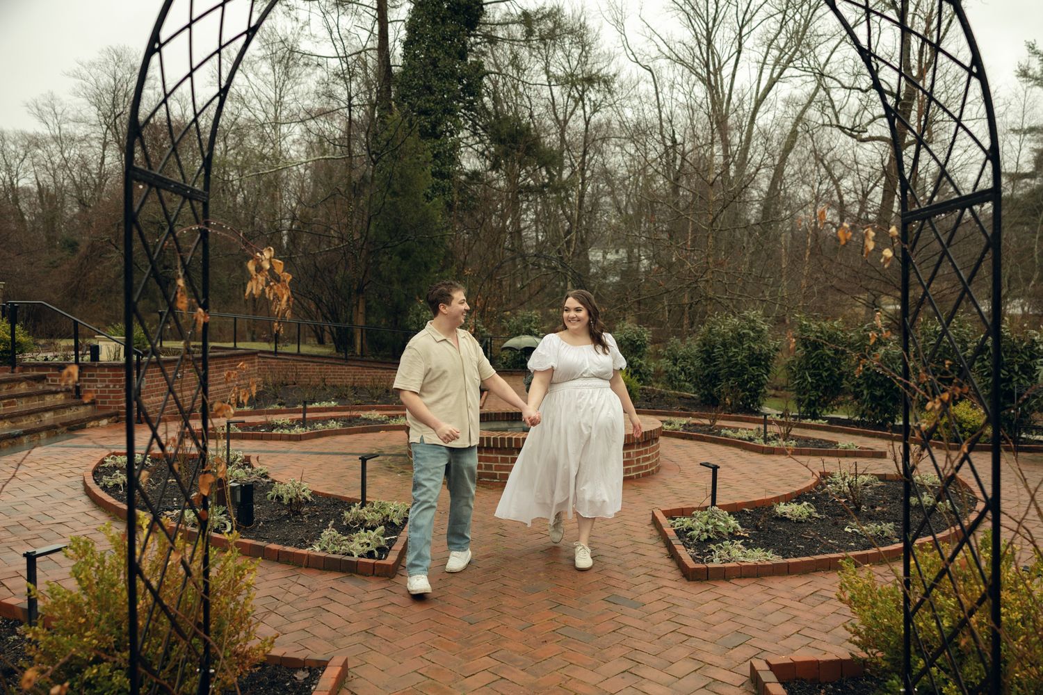 Romantic engagement photos at Appleford Estate near Philadelphia featuring a couple walking through lush gardens and historic architecture