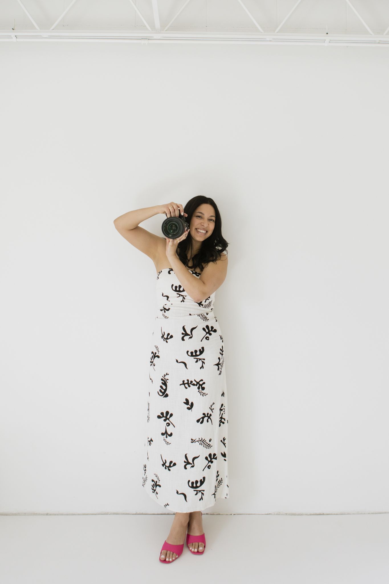 Brand photography in Philadelphia with a small business owner working on a laptop, styled desk details, and candid moments