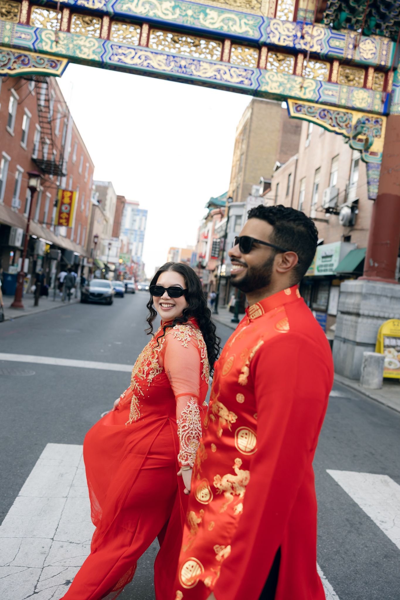 Engaged couple holding hands while strolling through Chinatown in Philadelphia during a candid engagement session-1.jpg