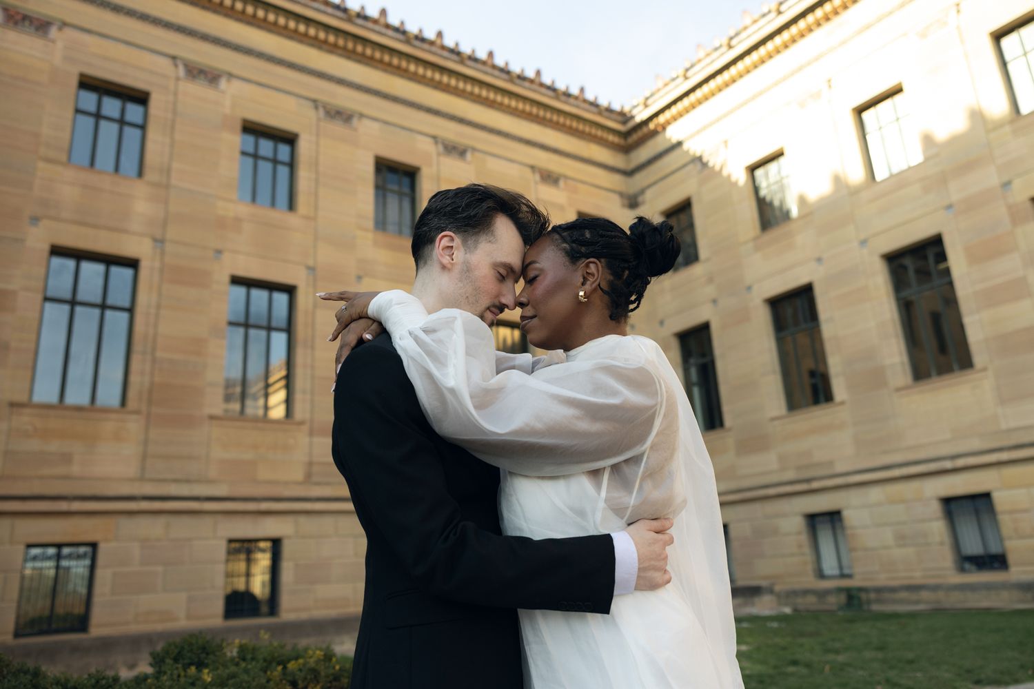 Editorial wedding photography of a bridal couple at the Philadelphia Museum of Art, modern romantic portraits with architectural backdrop