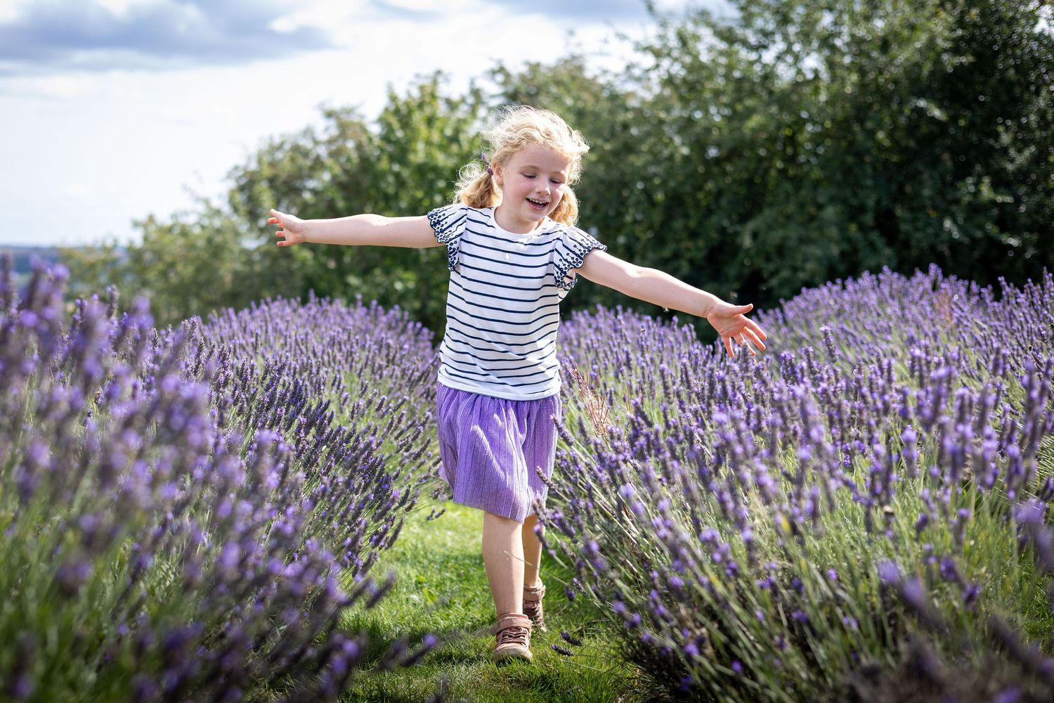 girl walking amongst lavender flowers