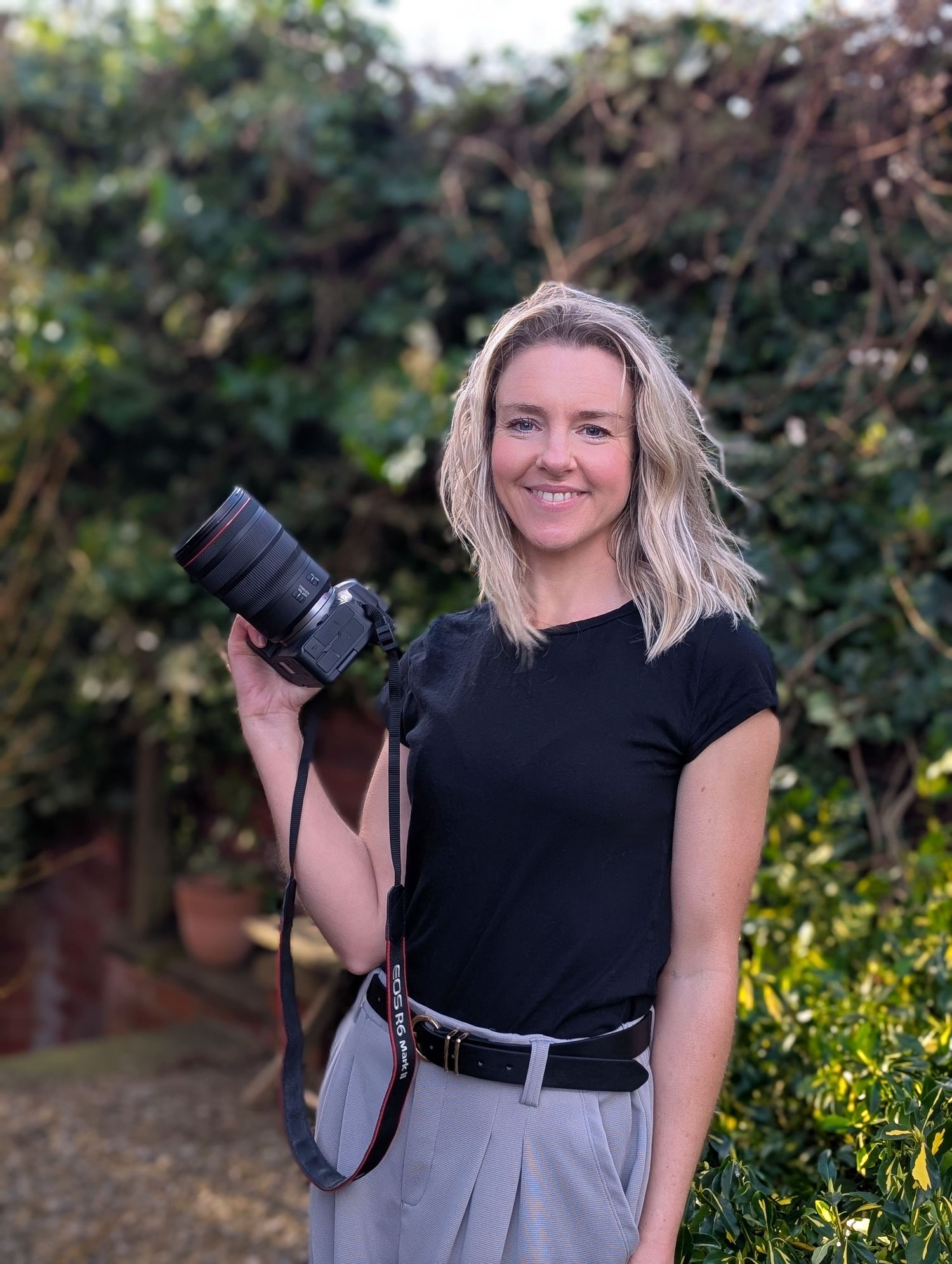 Photo of a woman holding a camera