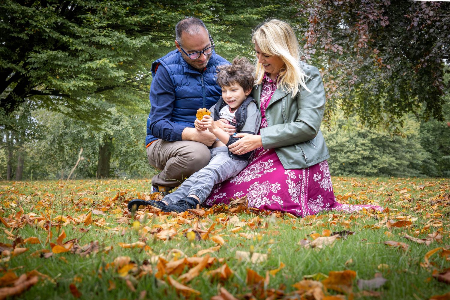 family sitting together in a park