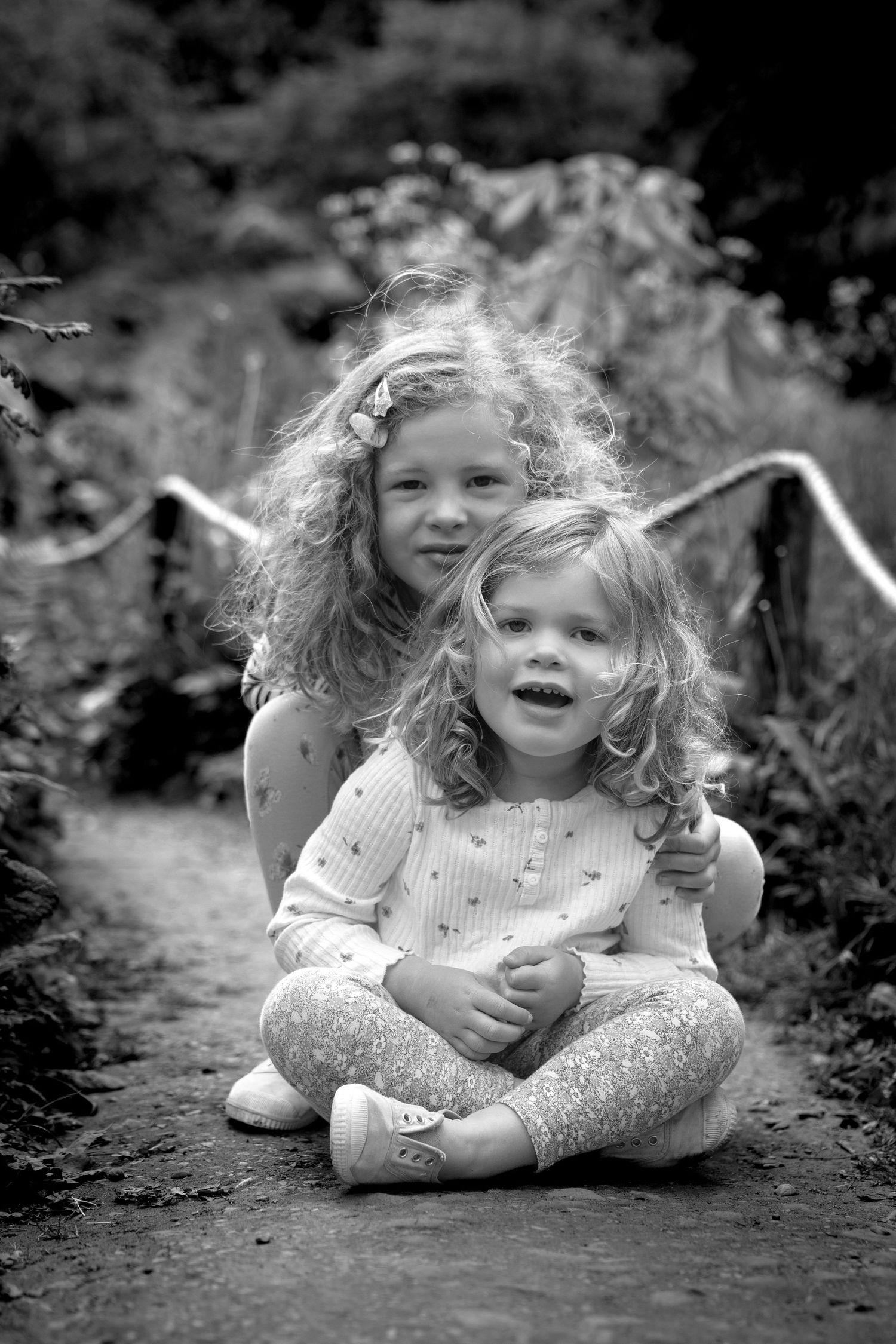 children sitting on a path