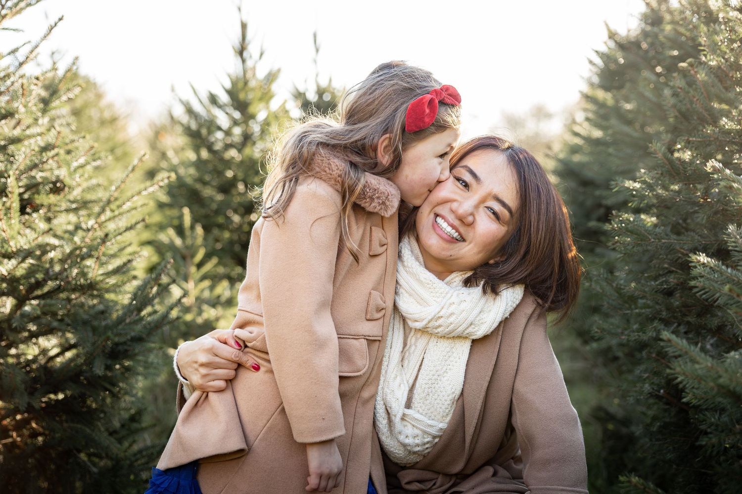 Mother and child in a Christmas tree farm