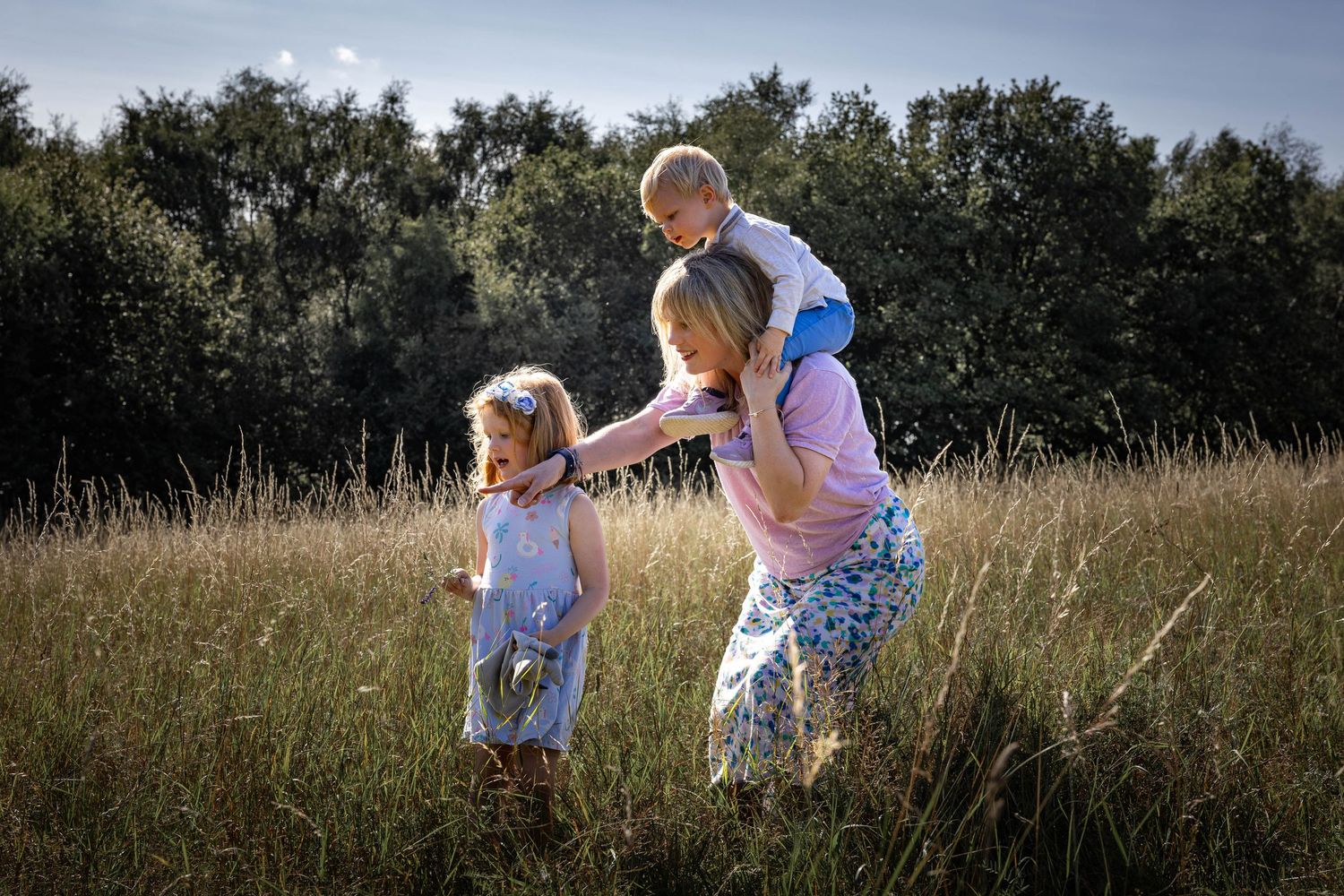 family playing in a grassy meadow