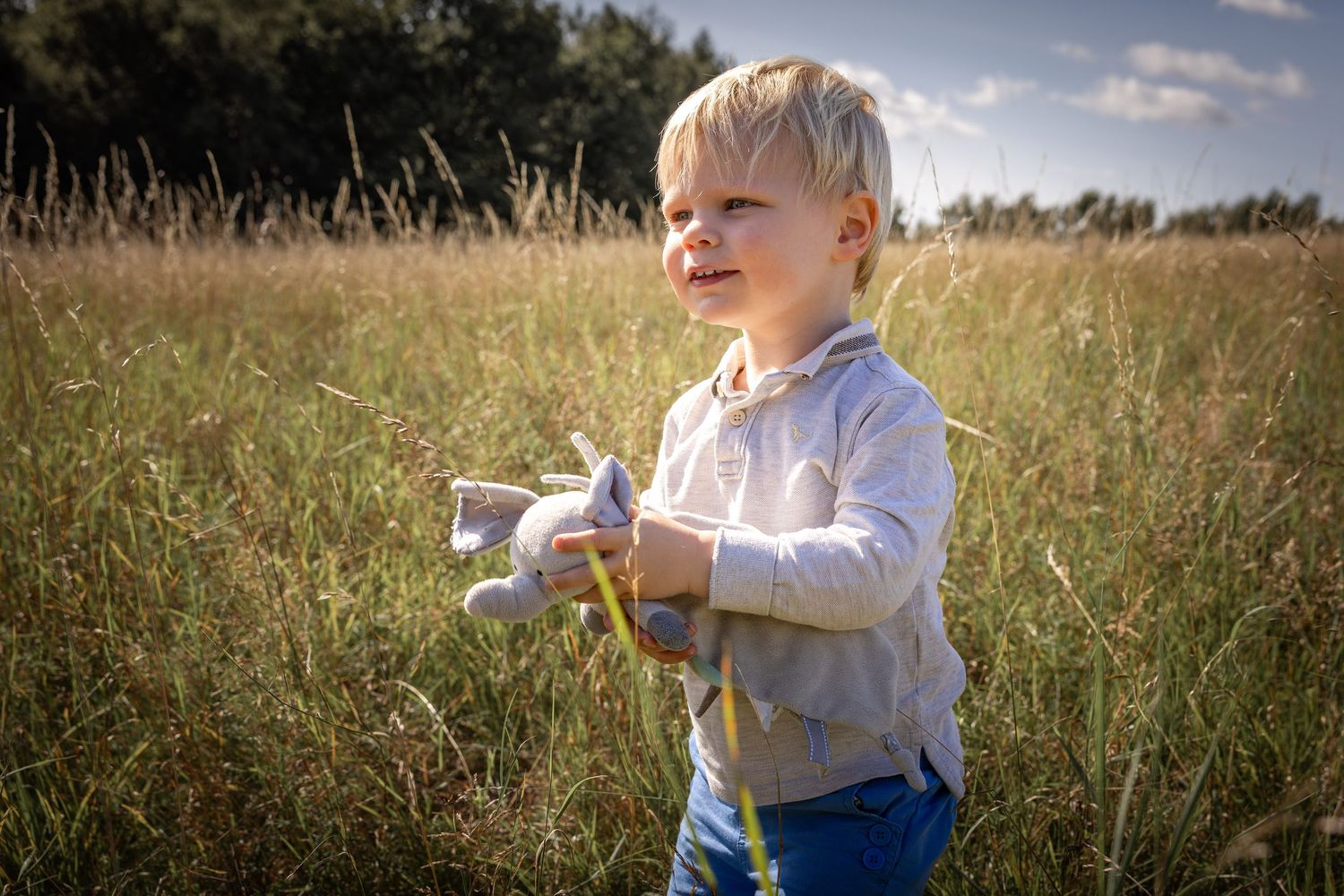 Boy standing in grassy meadow