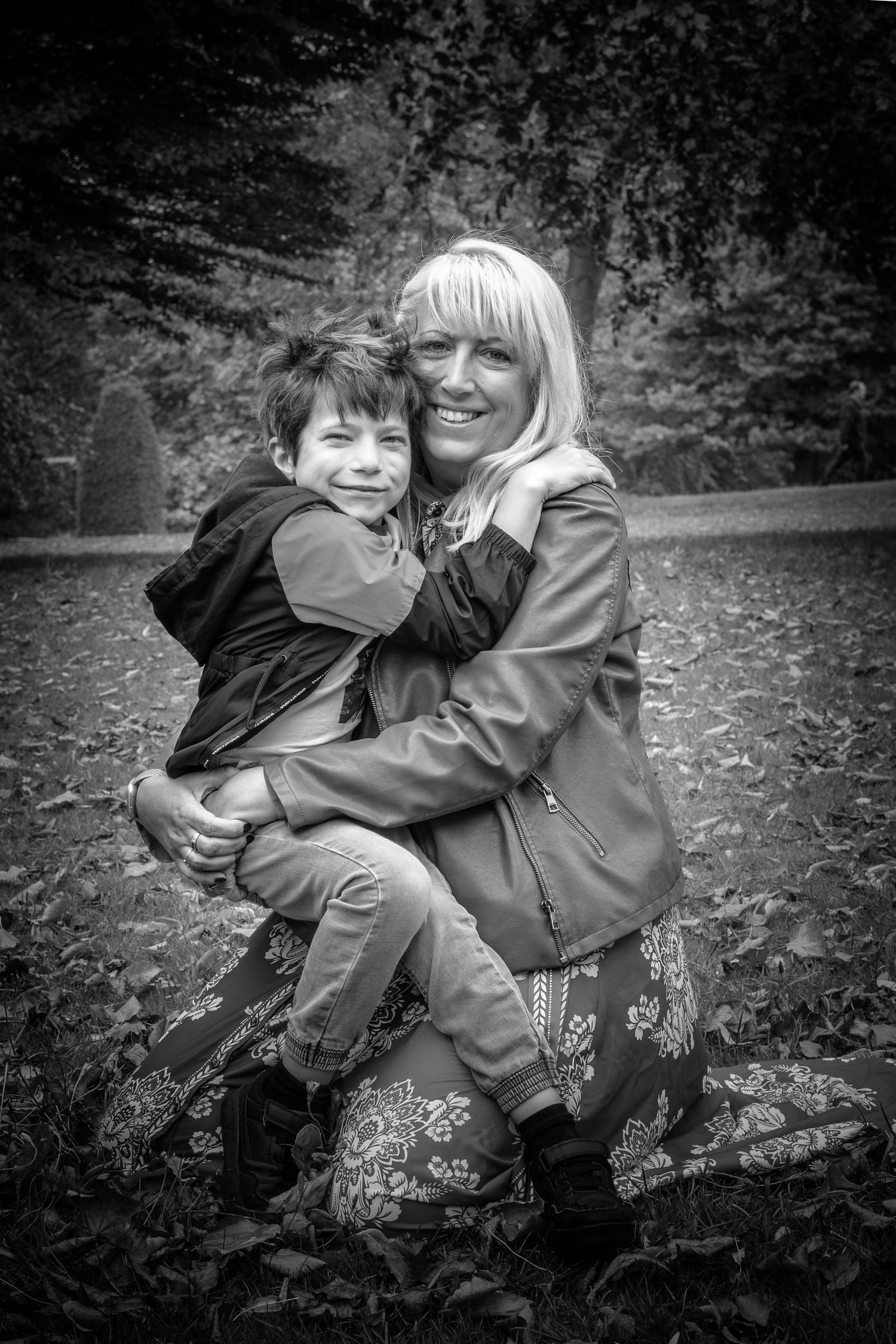 mother holding son in a park
