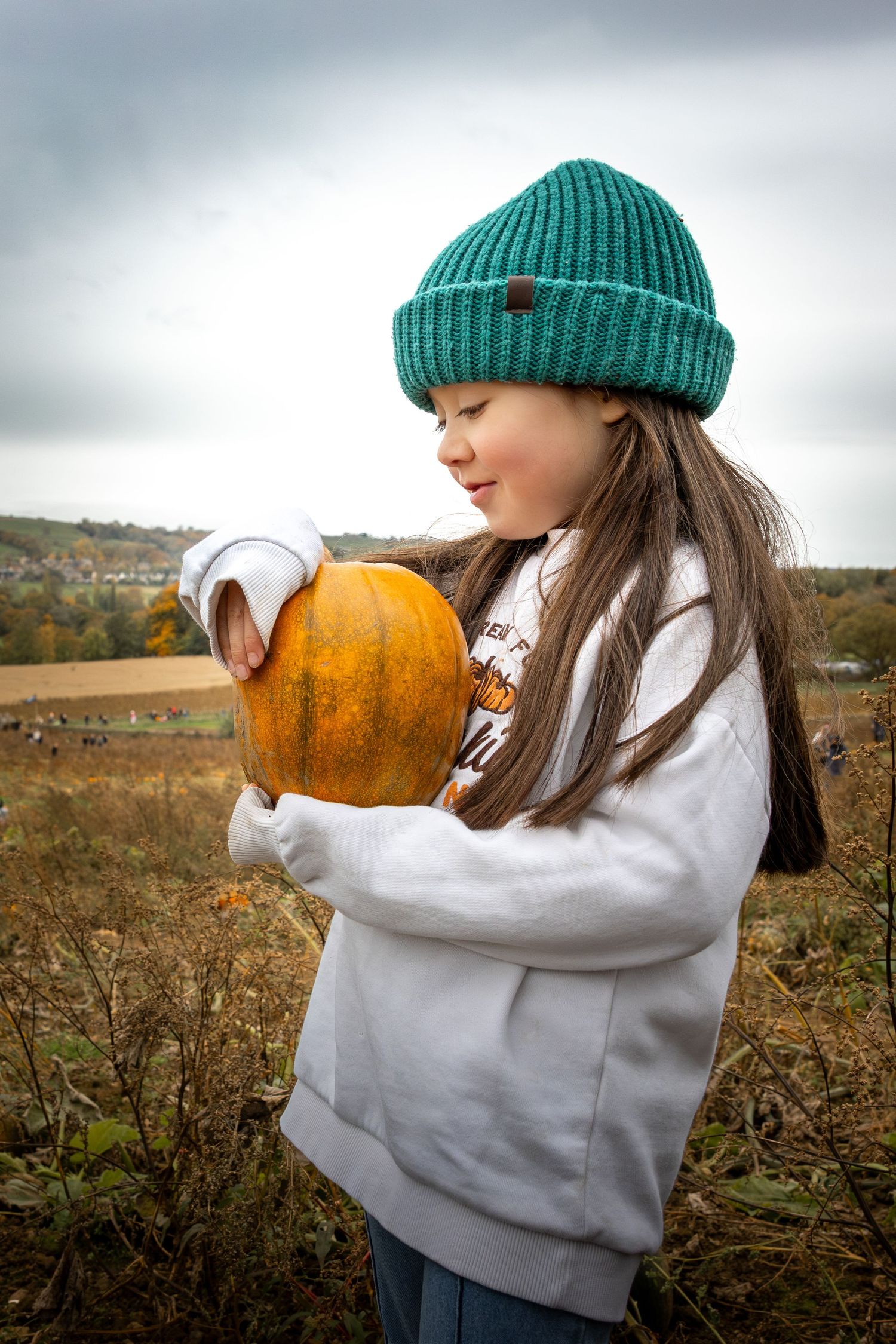 Child holding a pumpkin