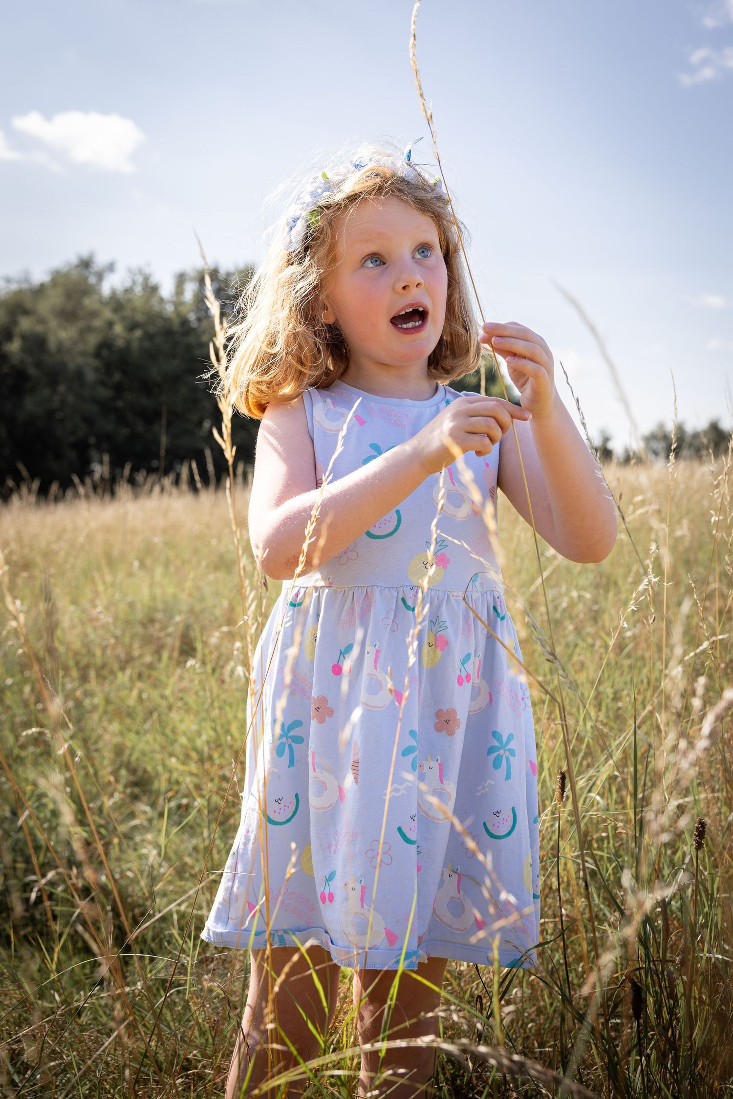 girls standing in grassy meadow