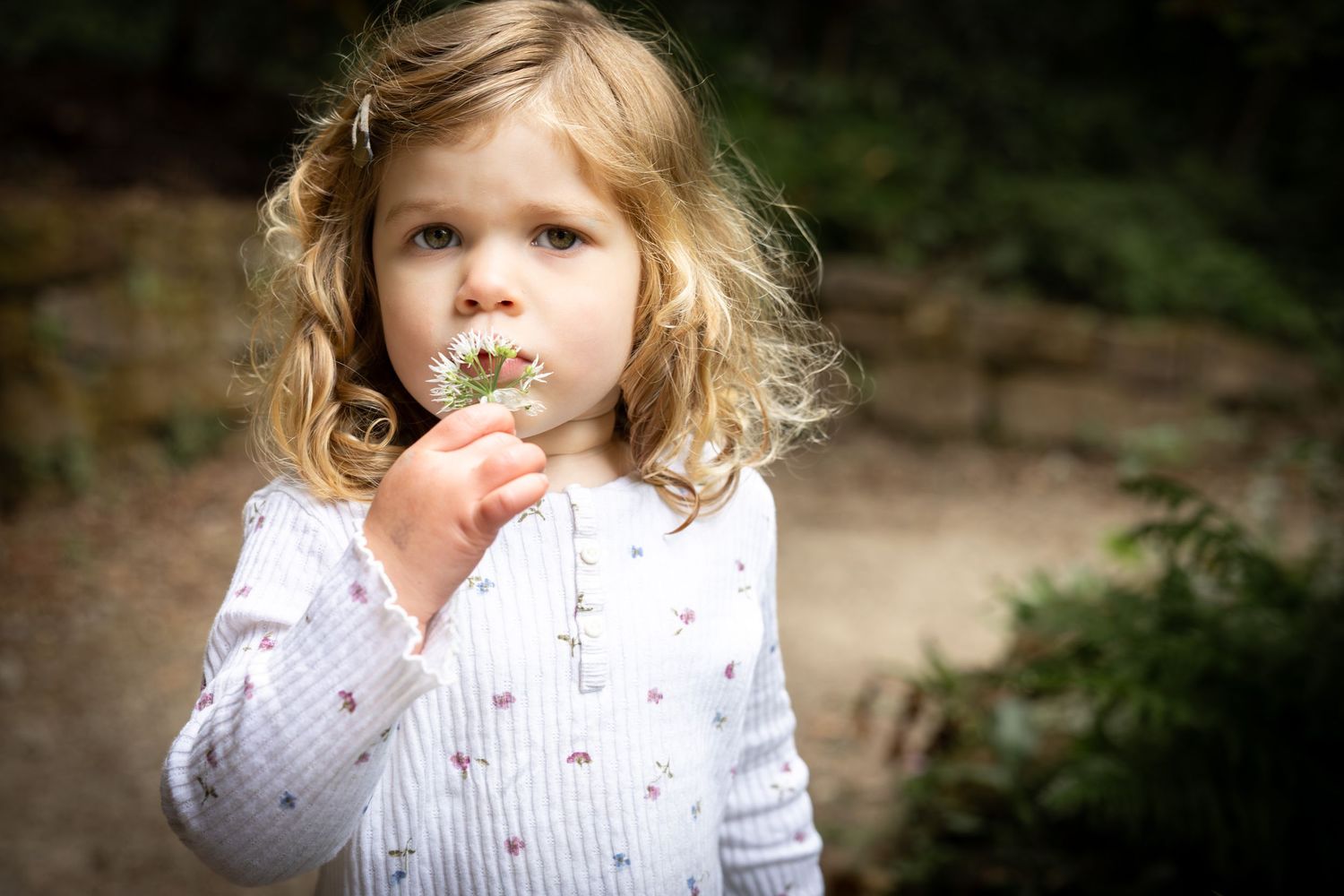 child smelling a flower