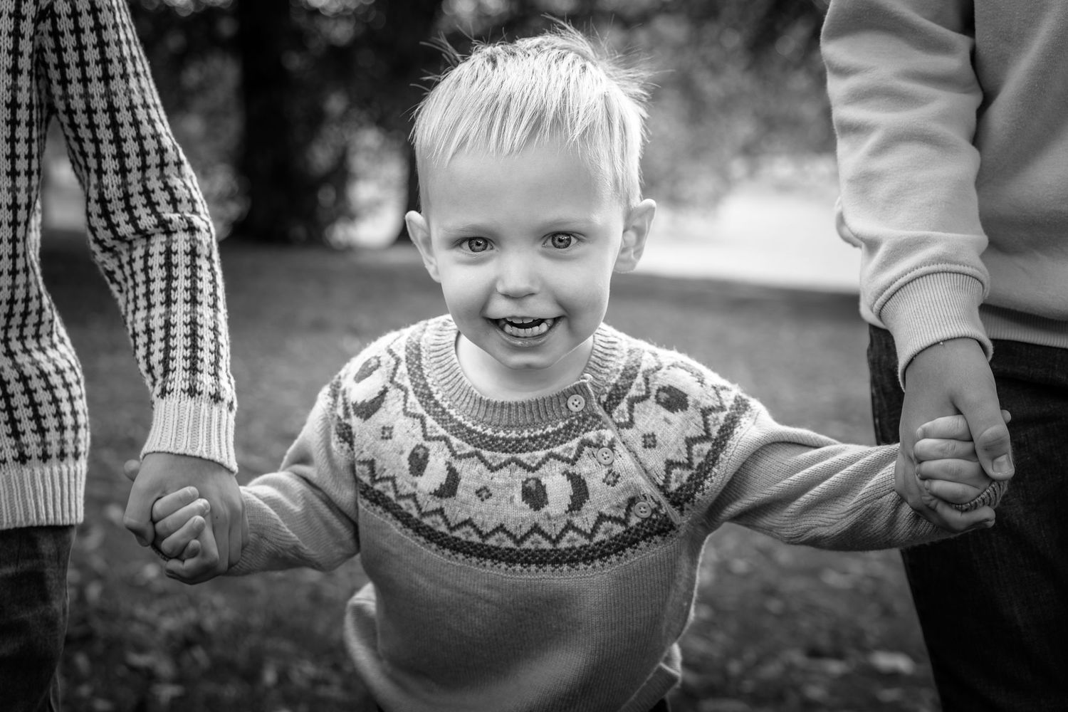 close up of child holding hands in a park
