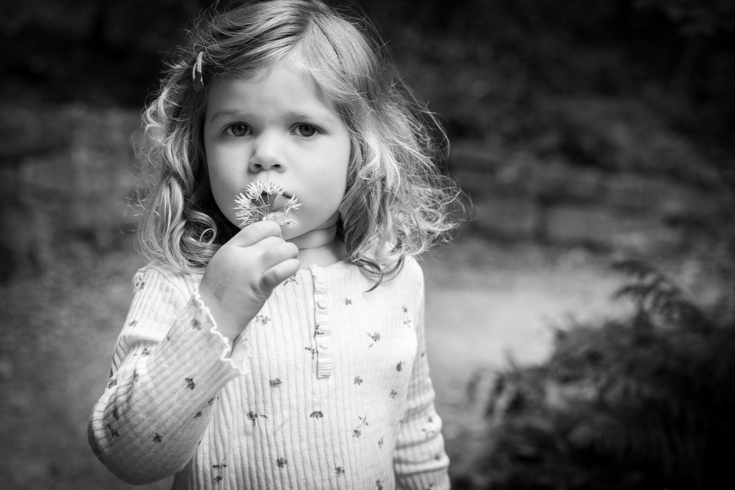 child smelling a flower