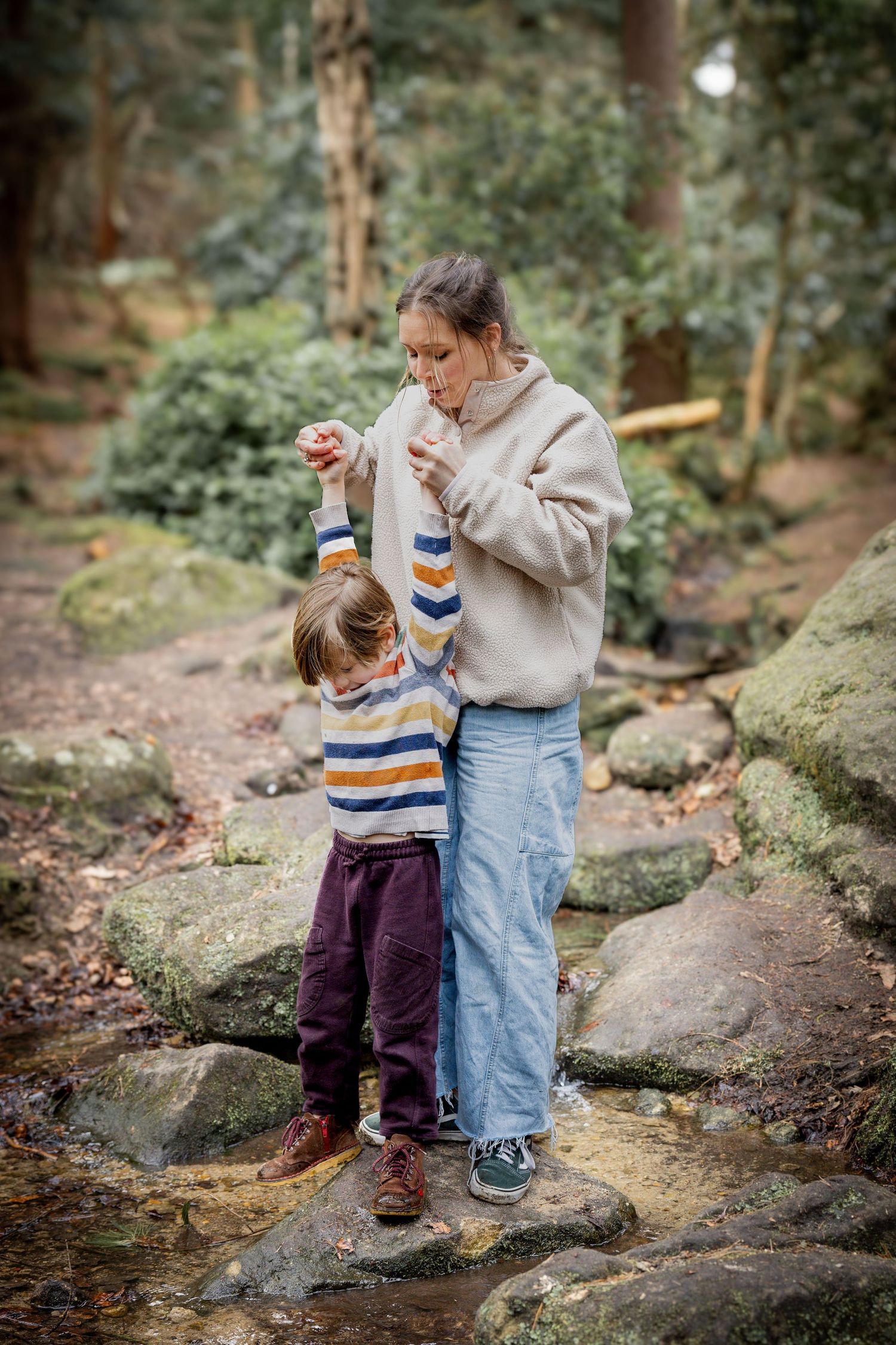 mother and son standing on rocks