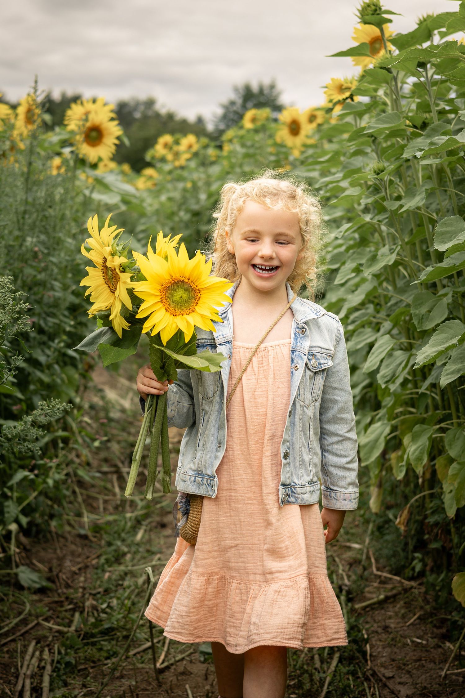 girl walking holding sunfowers