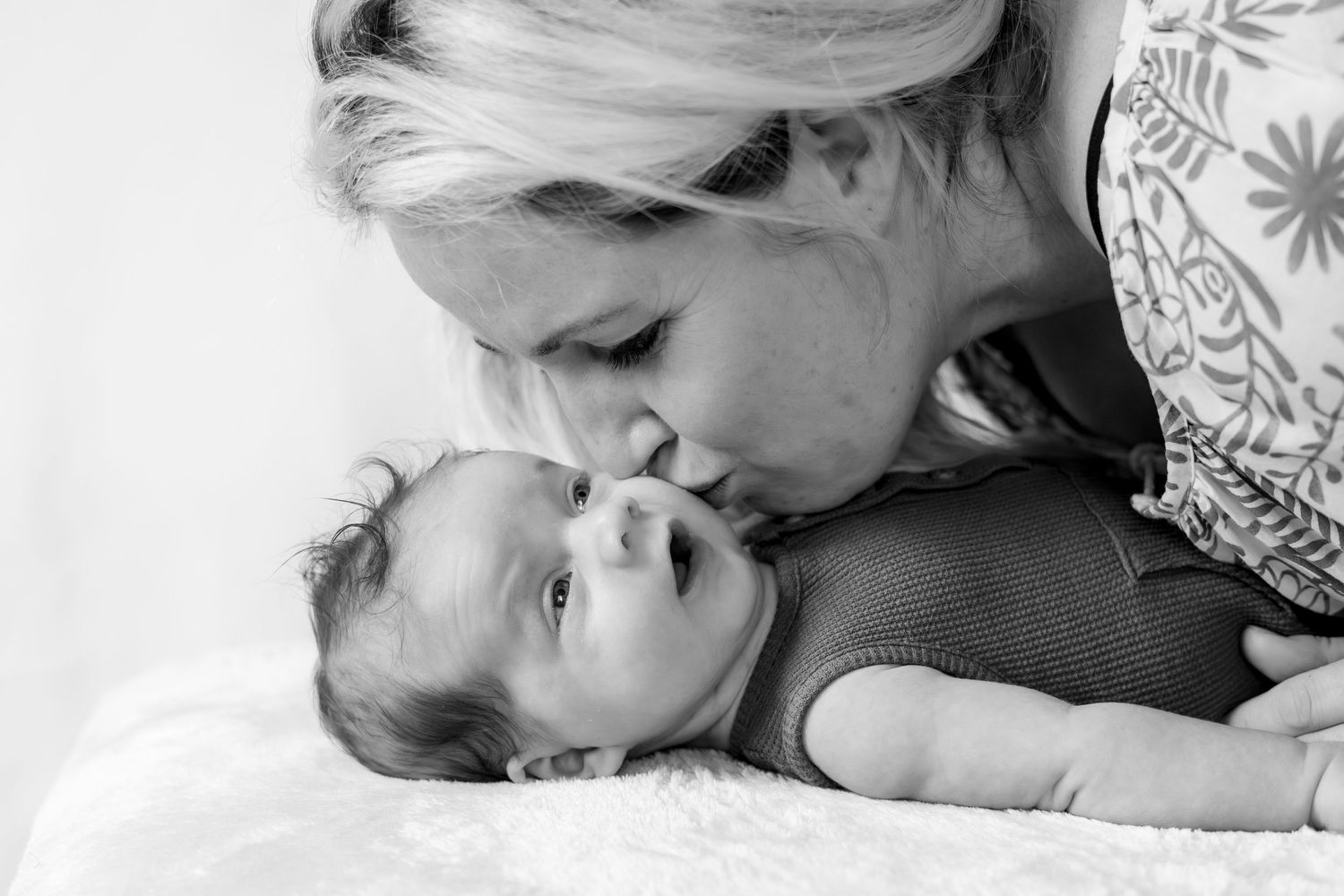 mother kissing baby