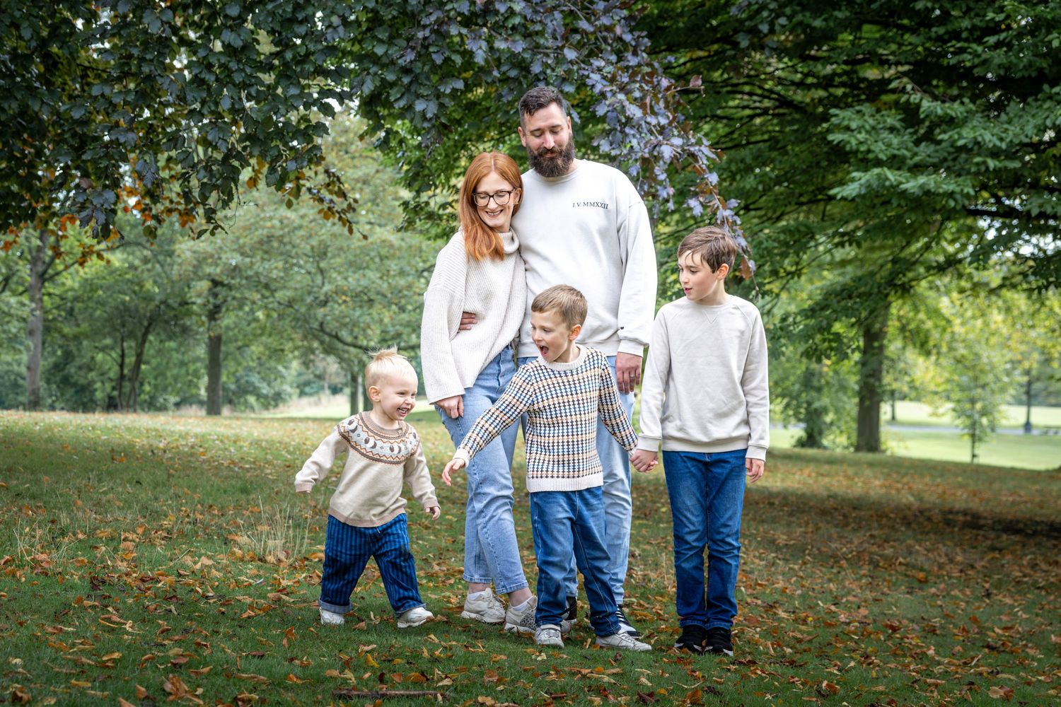 a family playing in a park with their children