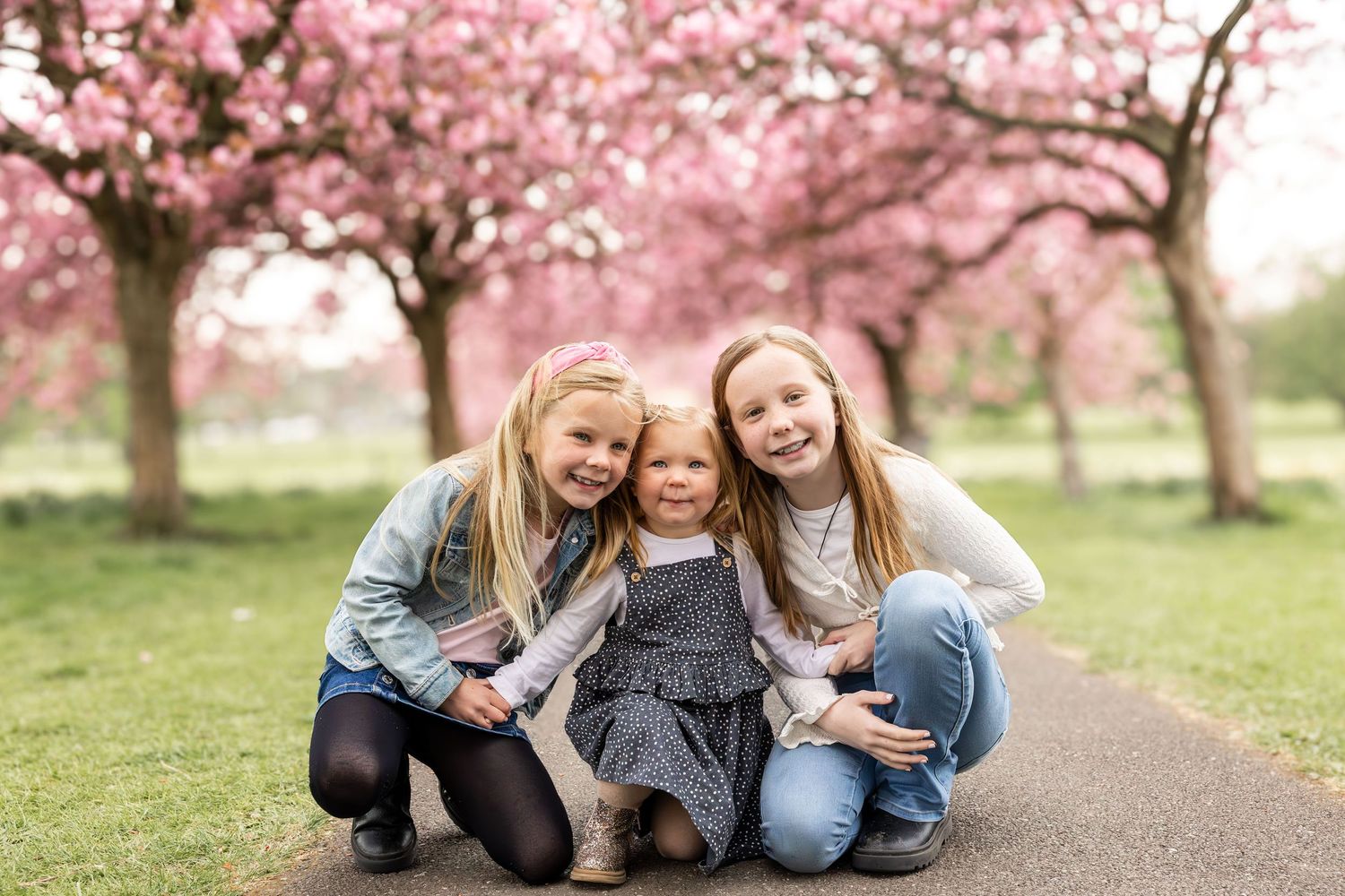 children sitting on a path in a park