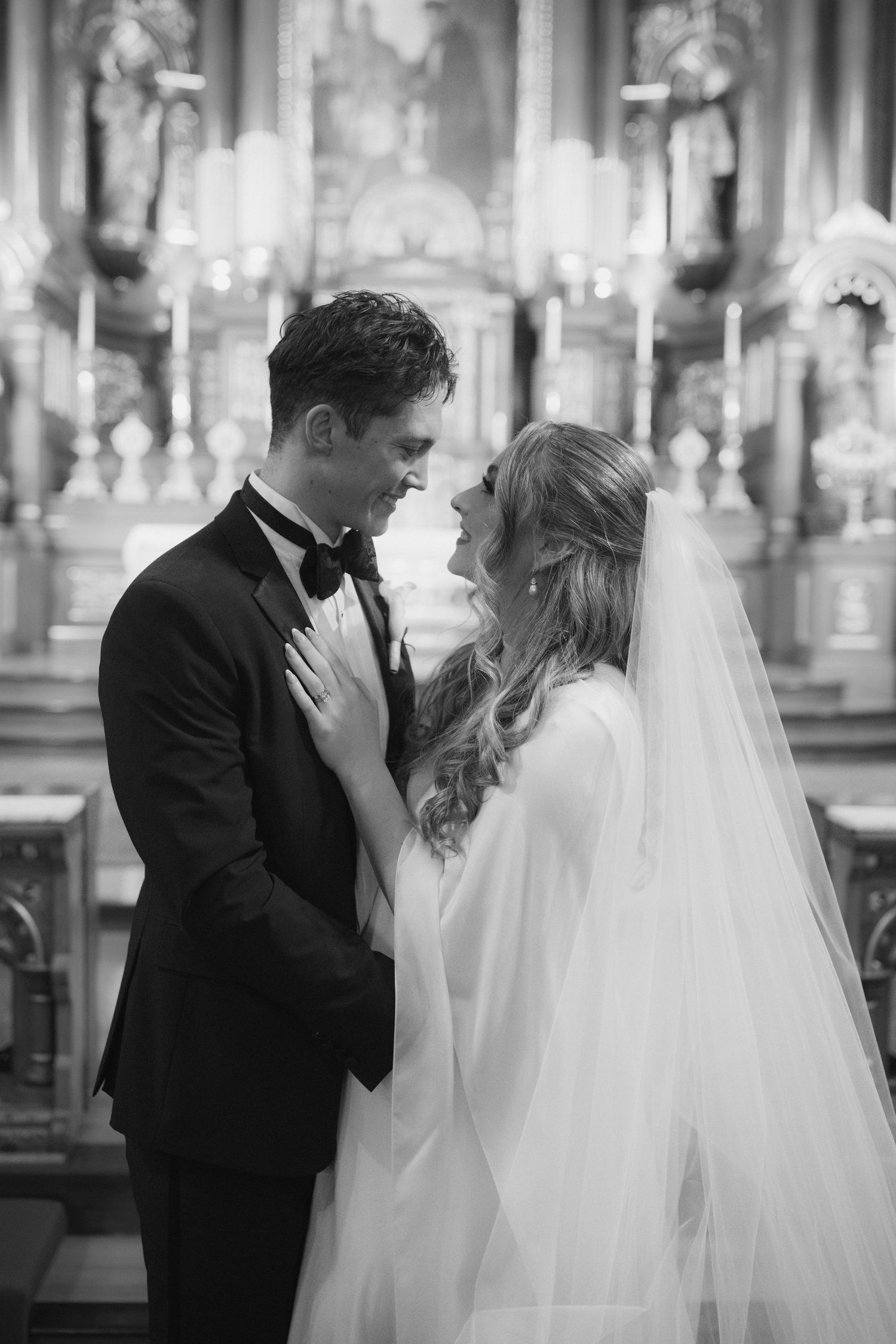 Intimate moment between newlyweds in an ornate church setting.