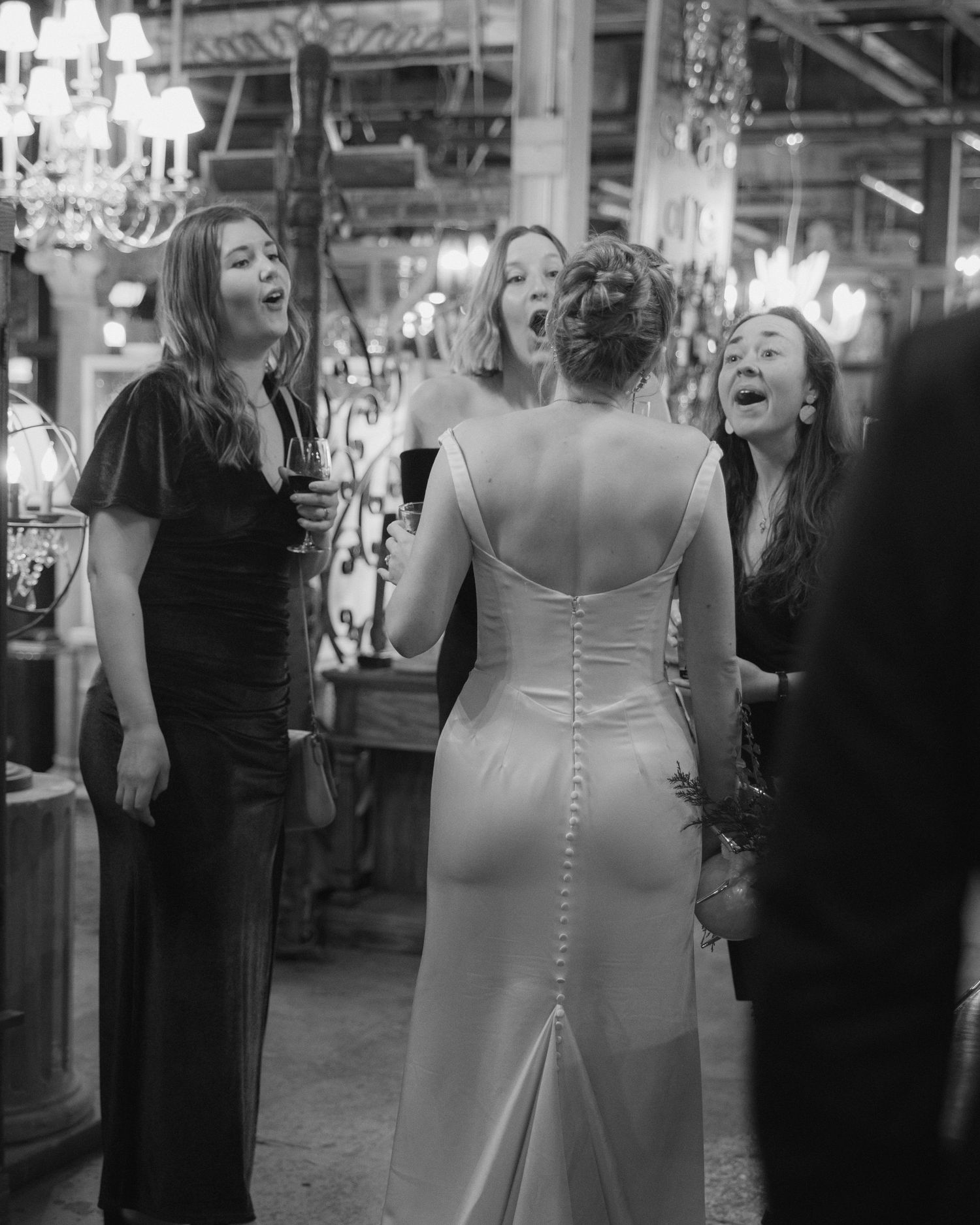 A sequence of black and white candid photos showing people laughing and celebrating at what appears to be a wedding reception.