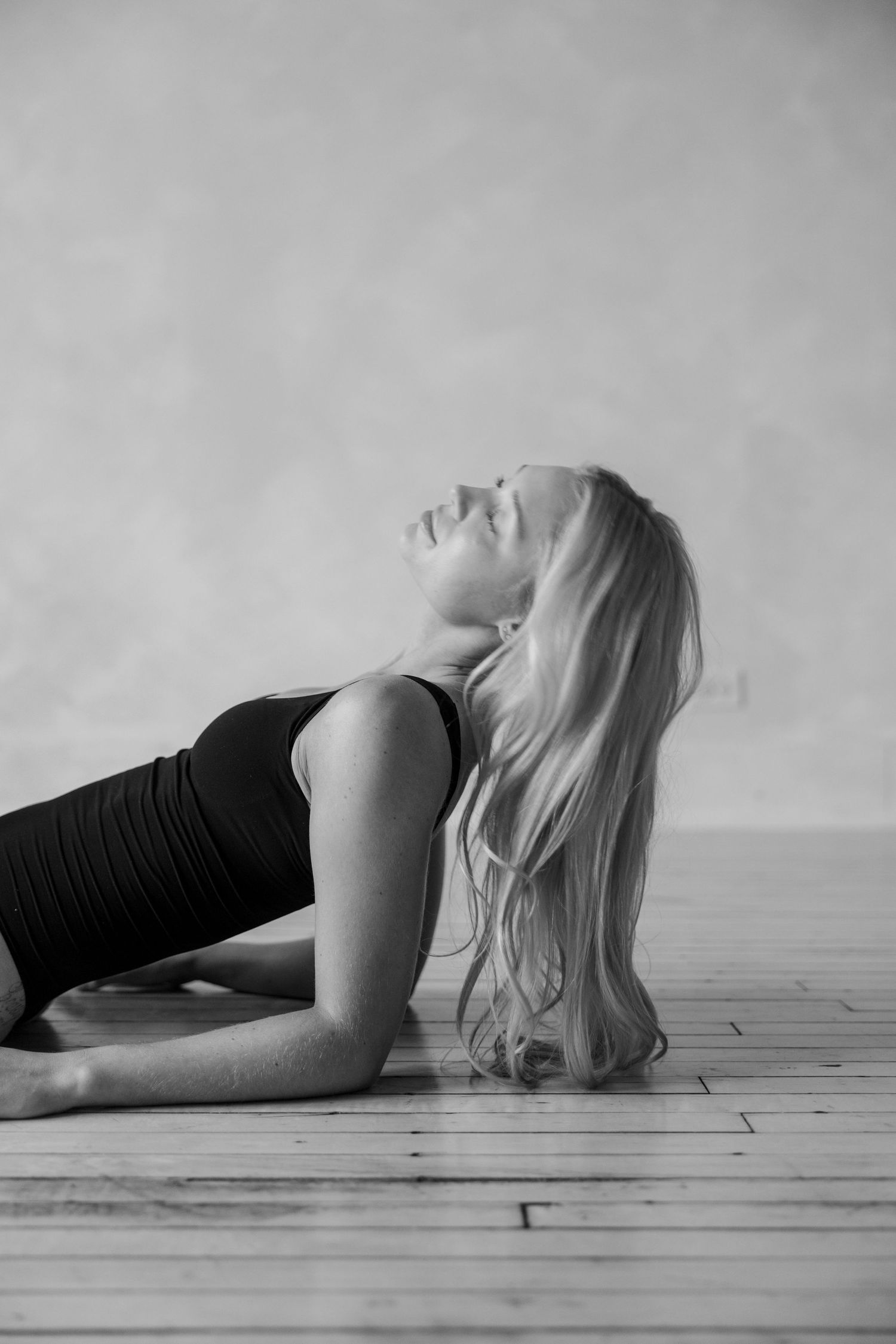 Dramatic black and white series of a person in flowing movement on a hardwood floor.
