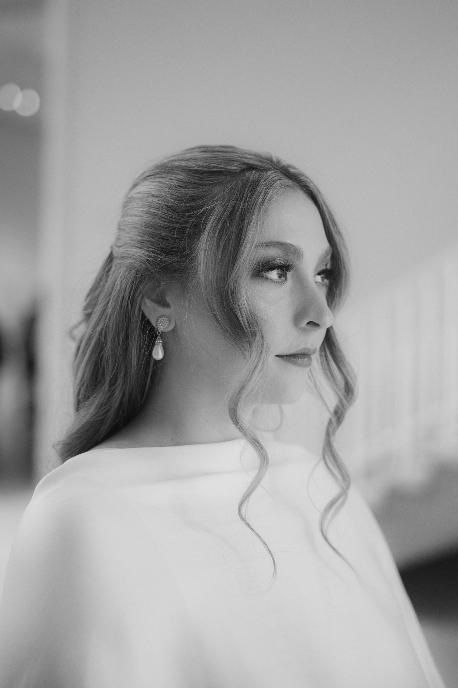 Black and white portrait series showing side profile angles with soft lighting and flowing hair.