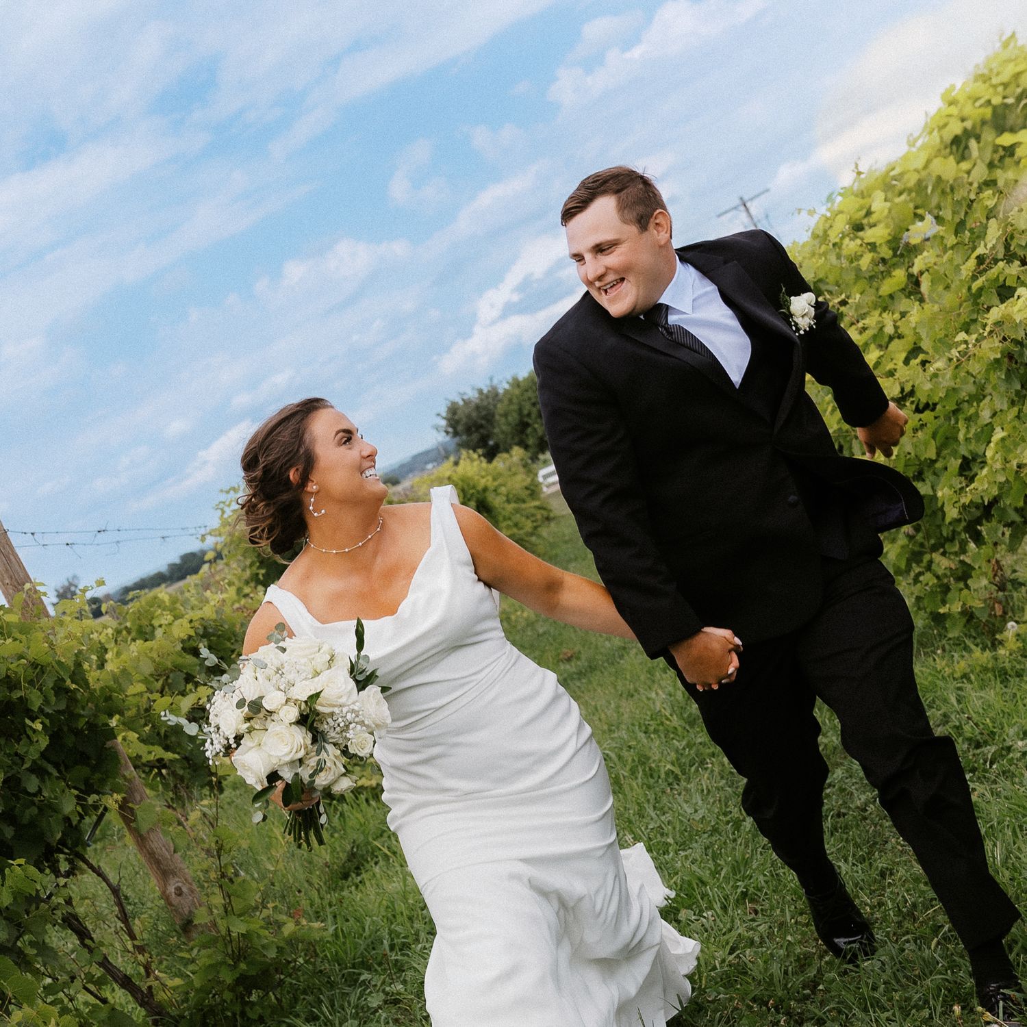 Playful wedding couple poses in a garden setting with dramatic dips and romantic gestures in a photo series.
