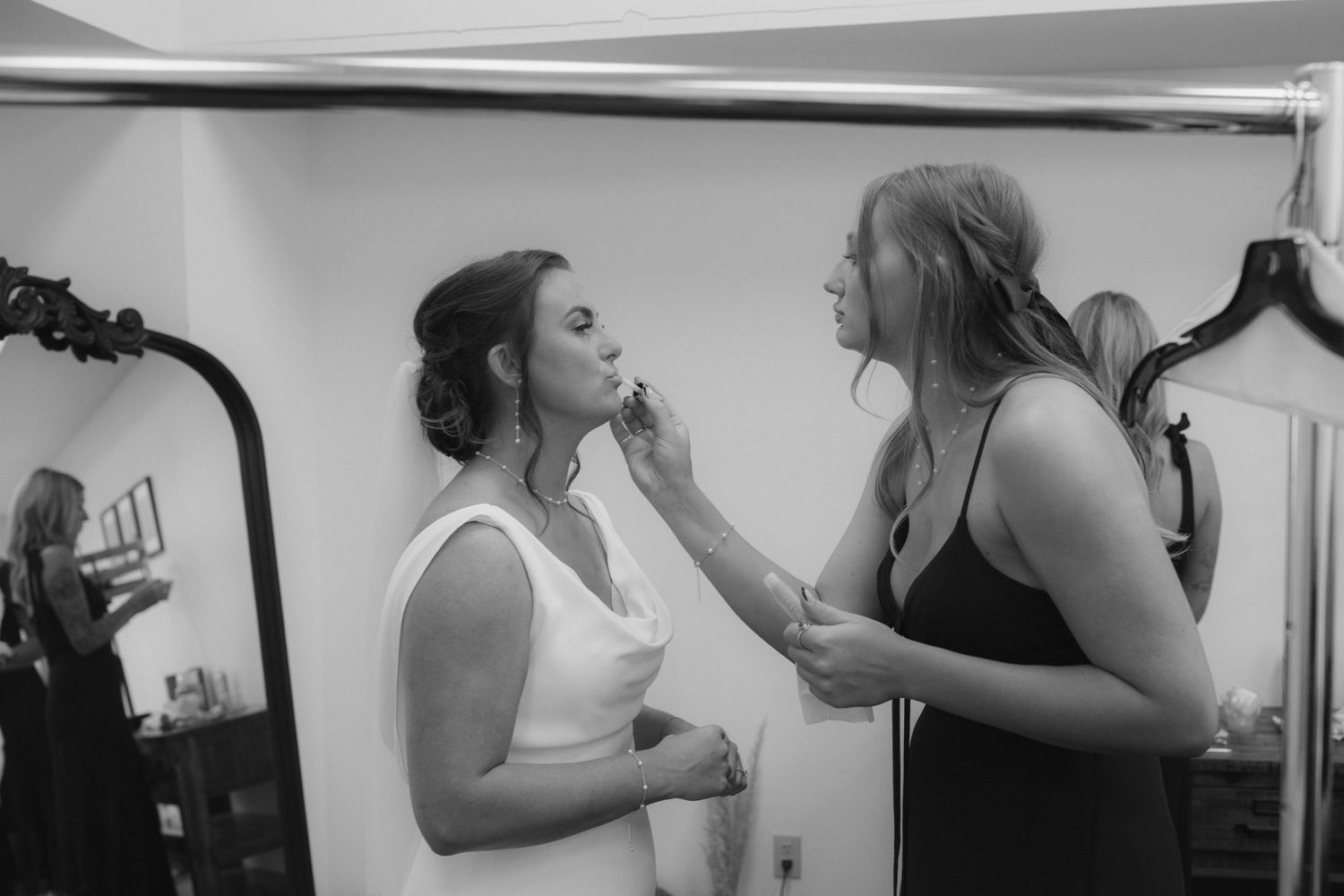 A series of black and white candid moments showing wedding preparations and getting ready scenes.