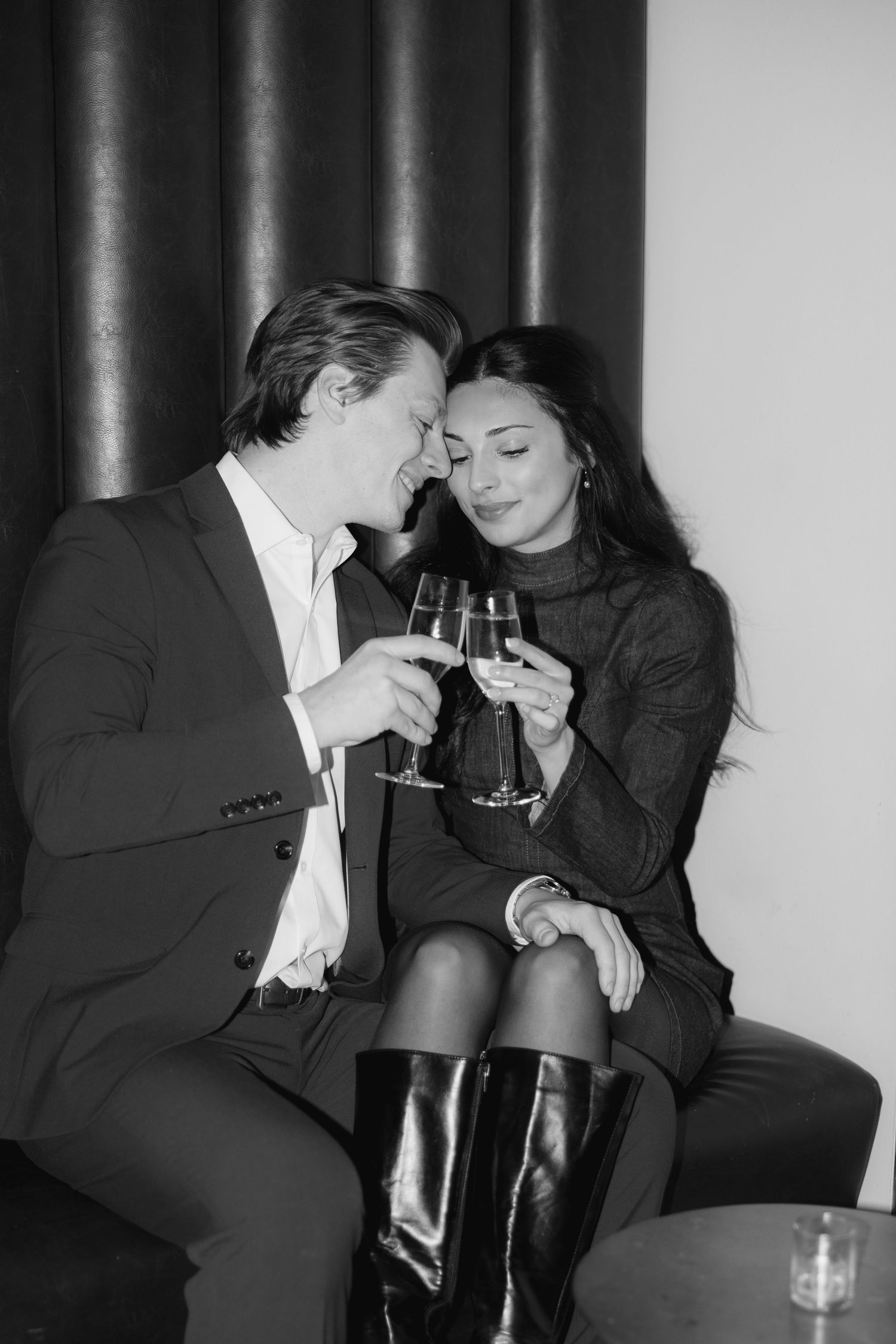 Black and white photos of two people sharing intimate moments at a bar counter.