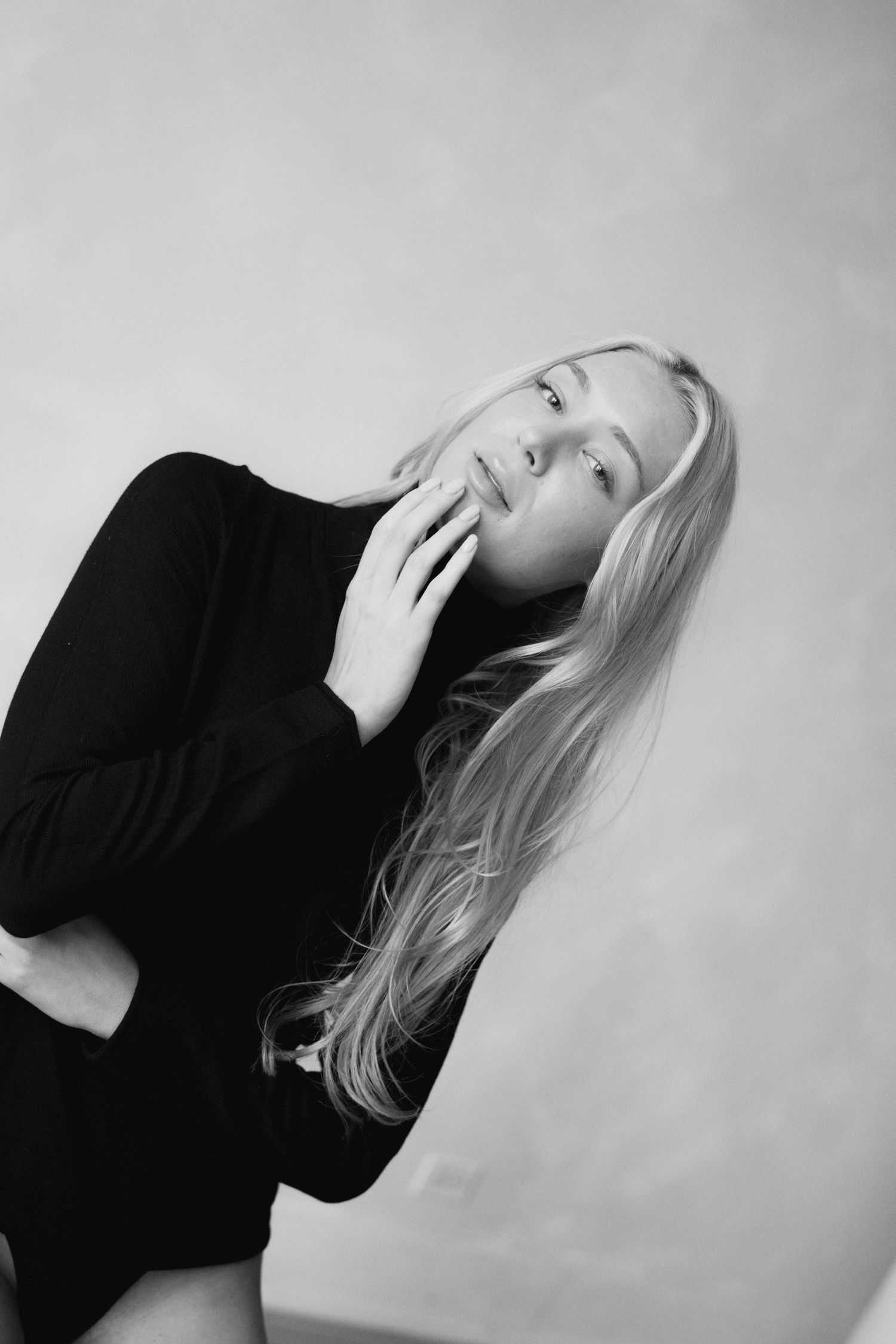 Artistic black and white portraits showing dramatic poses against a light background.