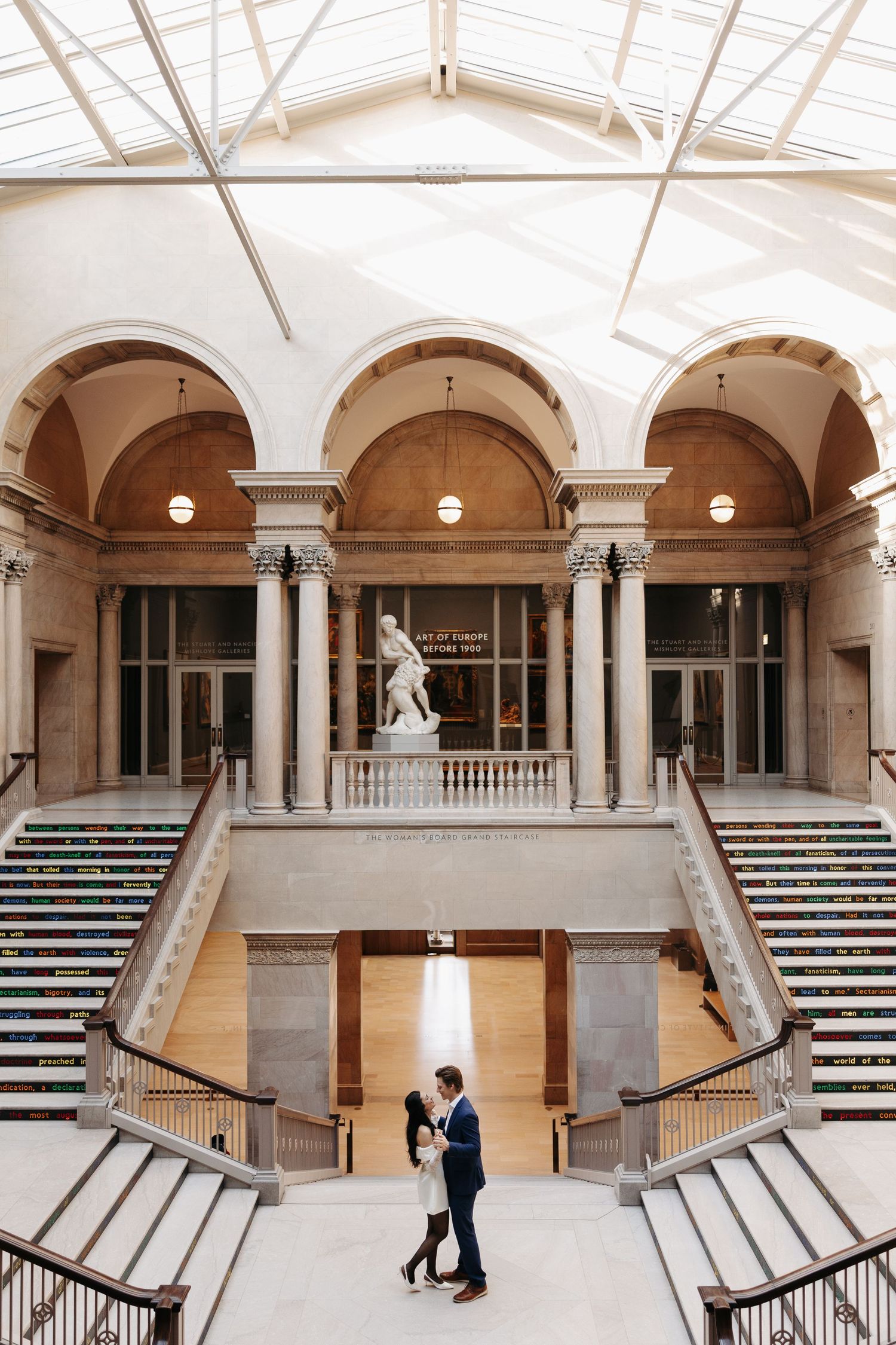 Grand architectural interior with white arches and columns in a historic building.