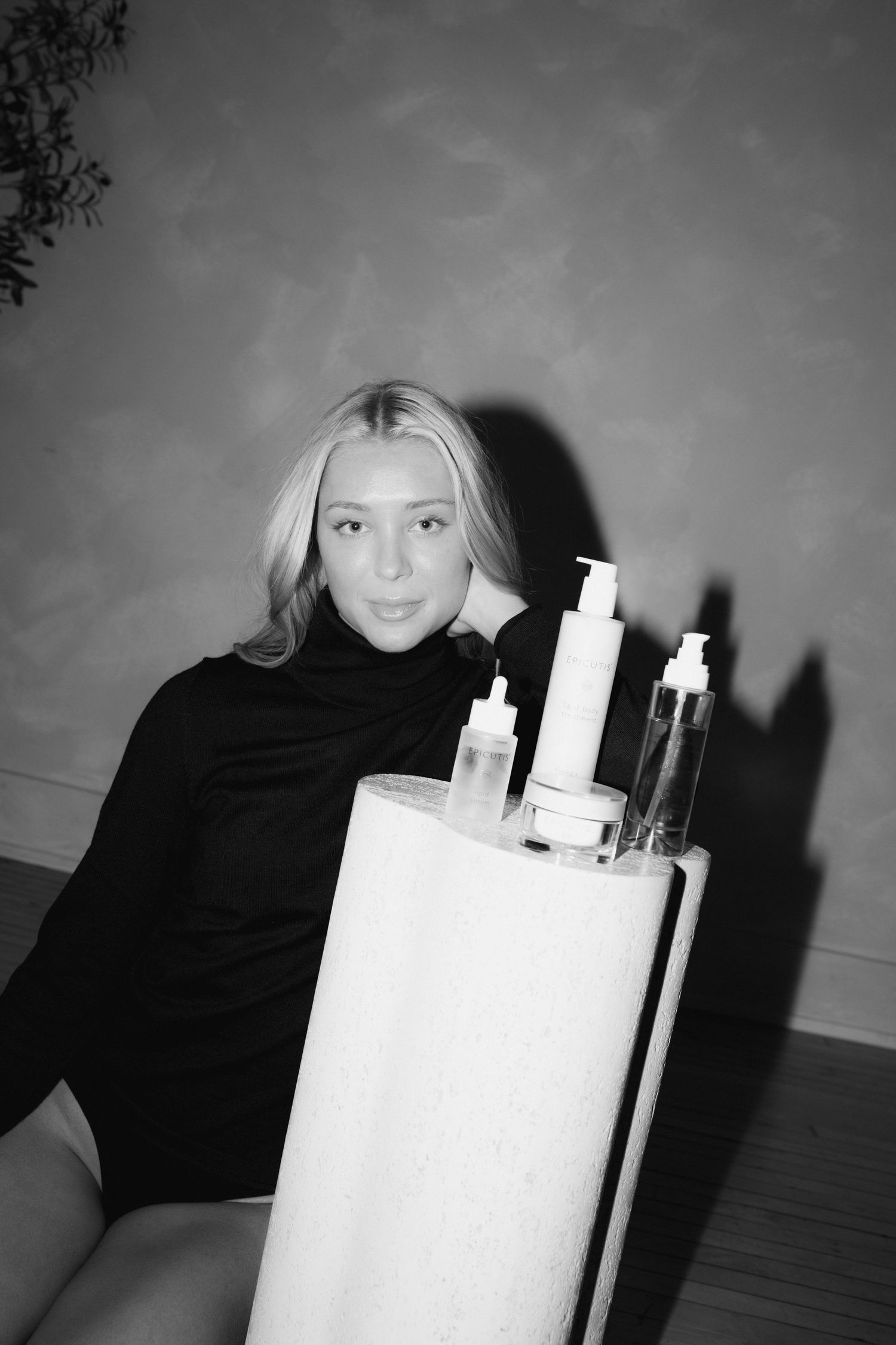 Black and white portrait sequence showing a person in dark clothing with white candles arranged in progressive poses.