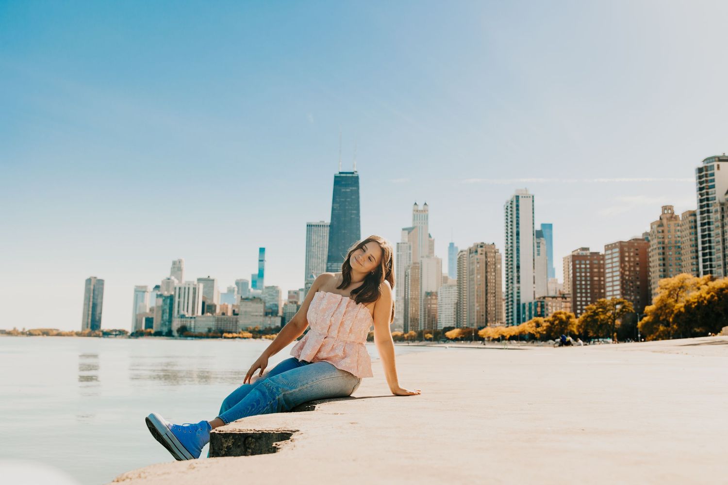 Casual portrait at North Avenue Beach with Chicago skyline in background.