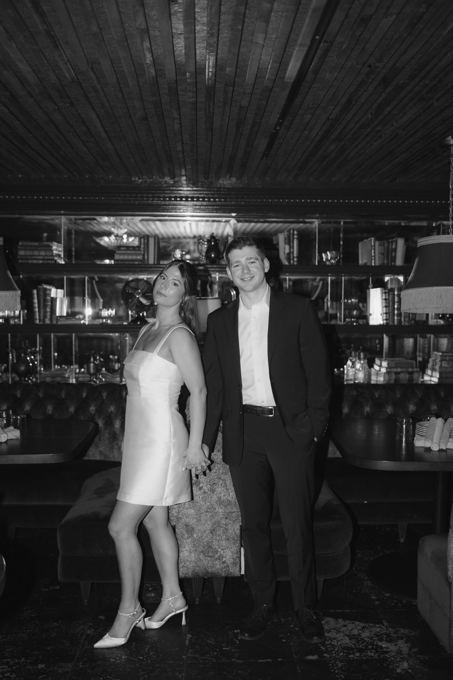 Black and white photos show people dancing and socializing at an indoor event with wood-paneled ceiling and dim lighting.