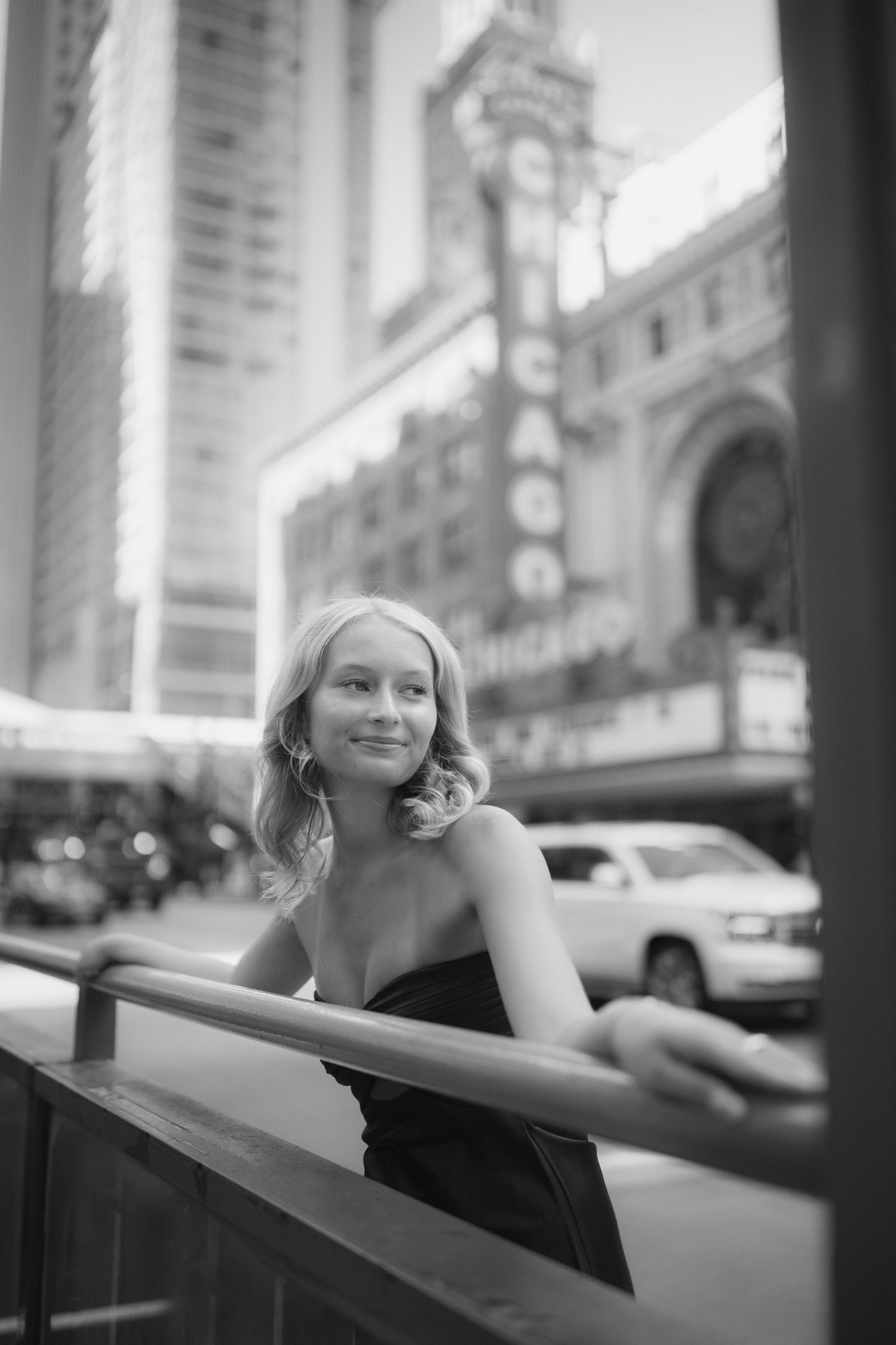 Black and white street photography with the Chicago Theatre marquee in background.