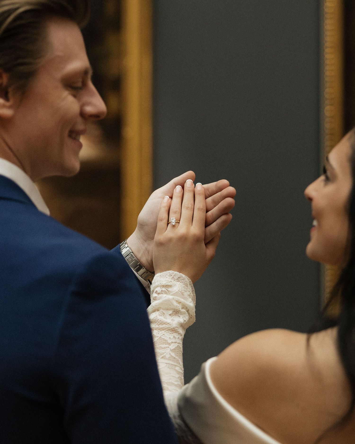 An intimate close-up moment between a couple in formal attire.