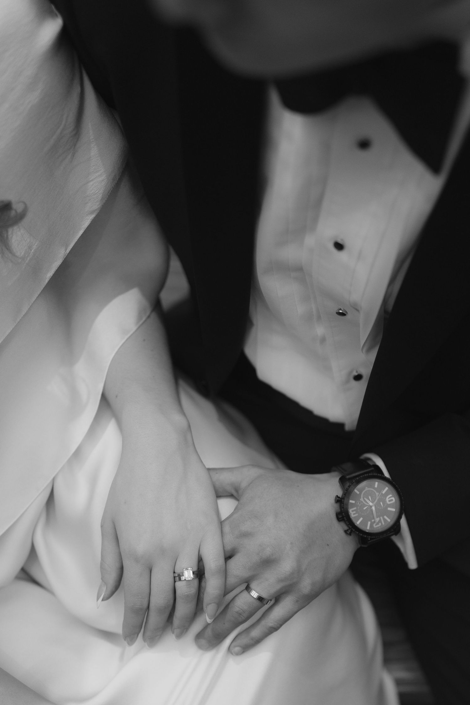 Black and white detail shots of wedding rings and formal attire.
